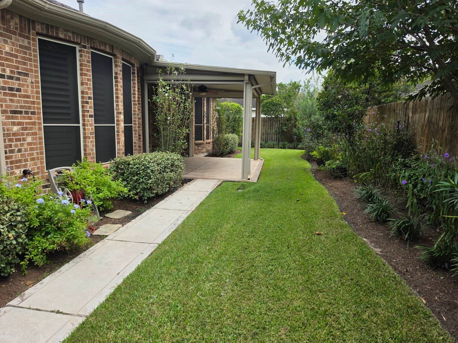 12619 Mossy Ledge Drive, Tomball, TX 77377 View of backyard with privacy screens up