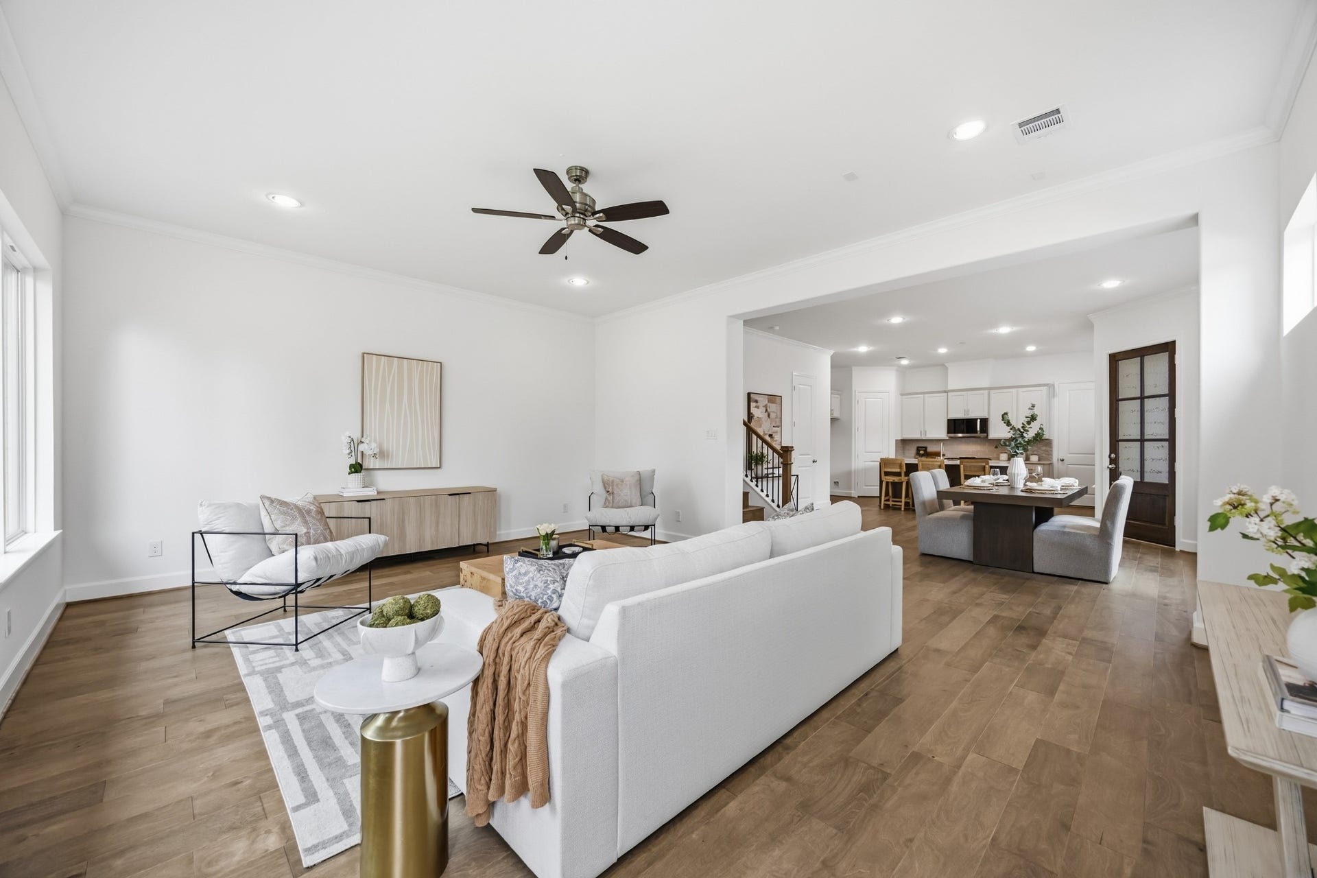5405 Nolda Street, Houston, TX 77007 Effortless Flow: The spacious living room, with standard wood flooring, seamlessly connects to the dining area, creating a welcoming space designed for comfort and entertaining.