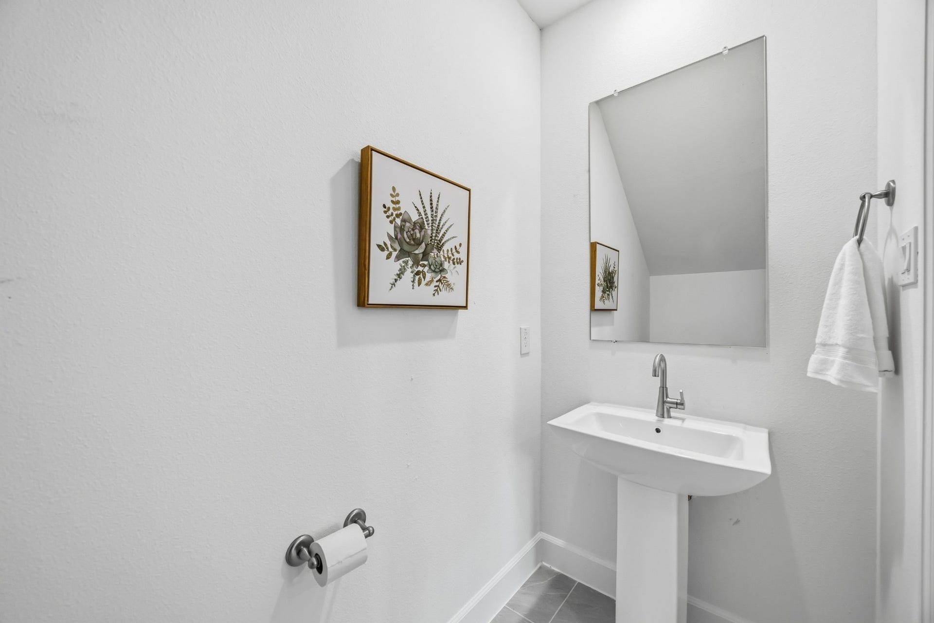 5405 Nolda Street, Houston, TX 77007 Convenient Style: The downstairs half bath combines practicality with a polished design, featuring a sleek pedestal sink and elegant fixtures, perfect for guests and everyday use.