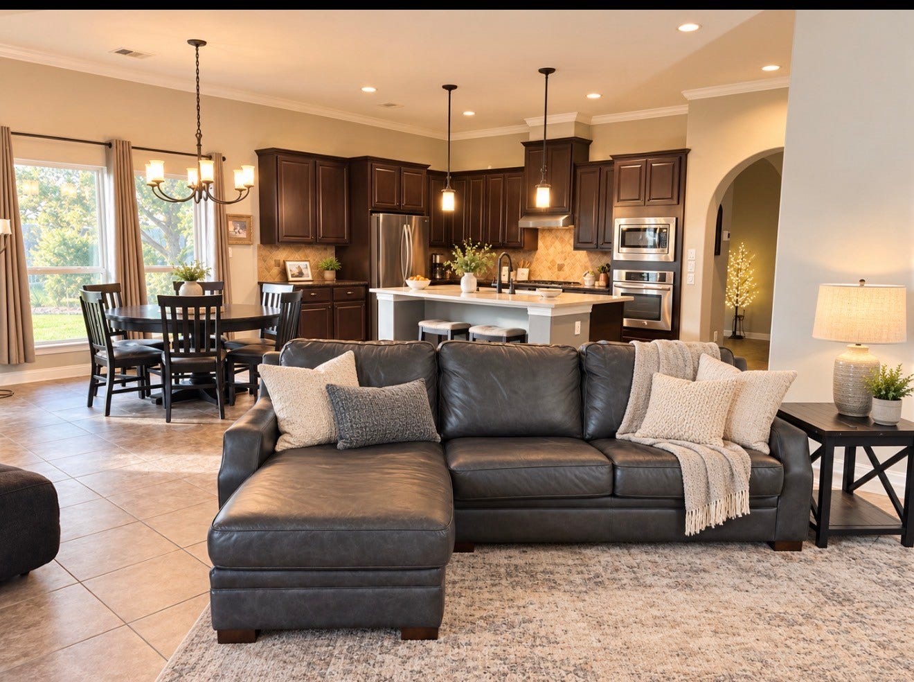 6902 Ladera Lane, Missouri City, TX 77459 Spacious open-concept kitchen and family room with high ceilings, abundant natural light, large island with seating and an easy flow to the dining areaperfect for everyday living and entertaining.