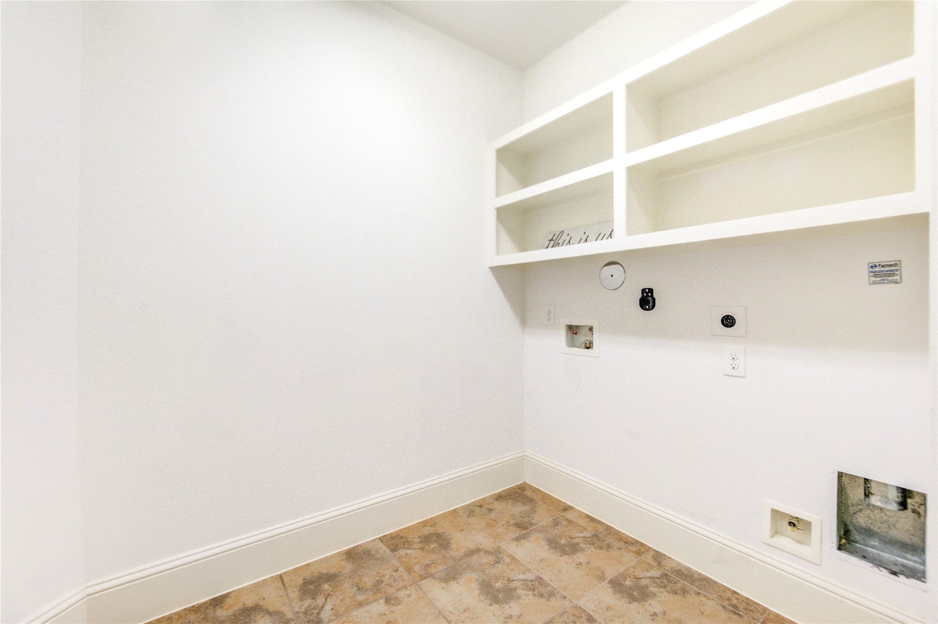 Ample utility room with built-in shelves