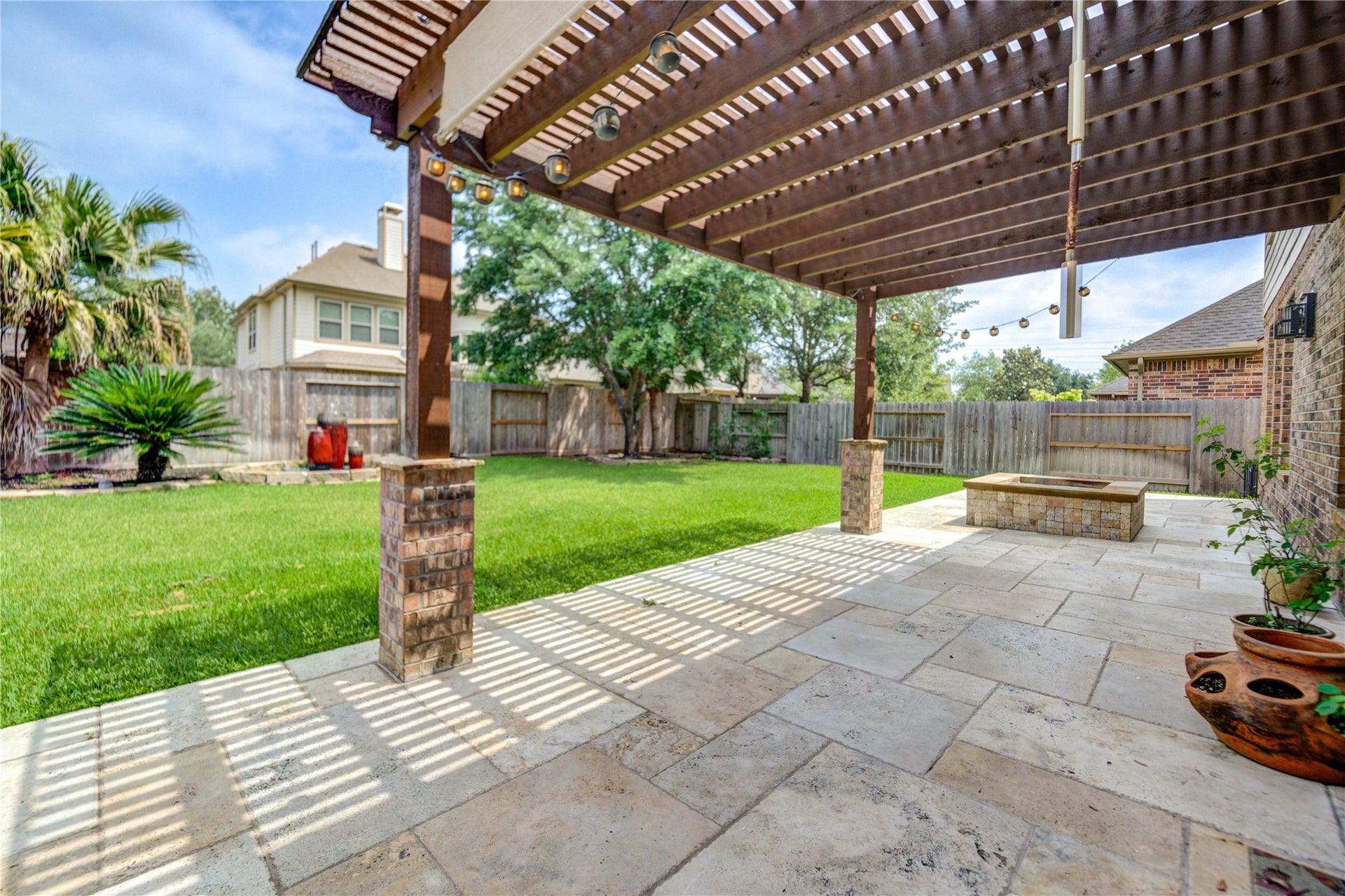 Backyard is very cozy with a pergola, fire pit and extended patio.