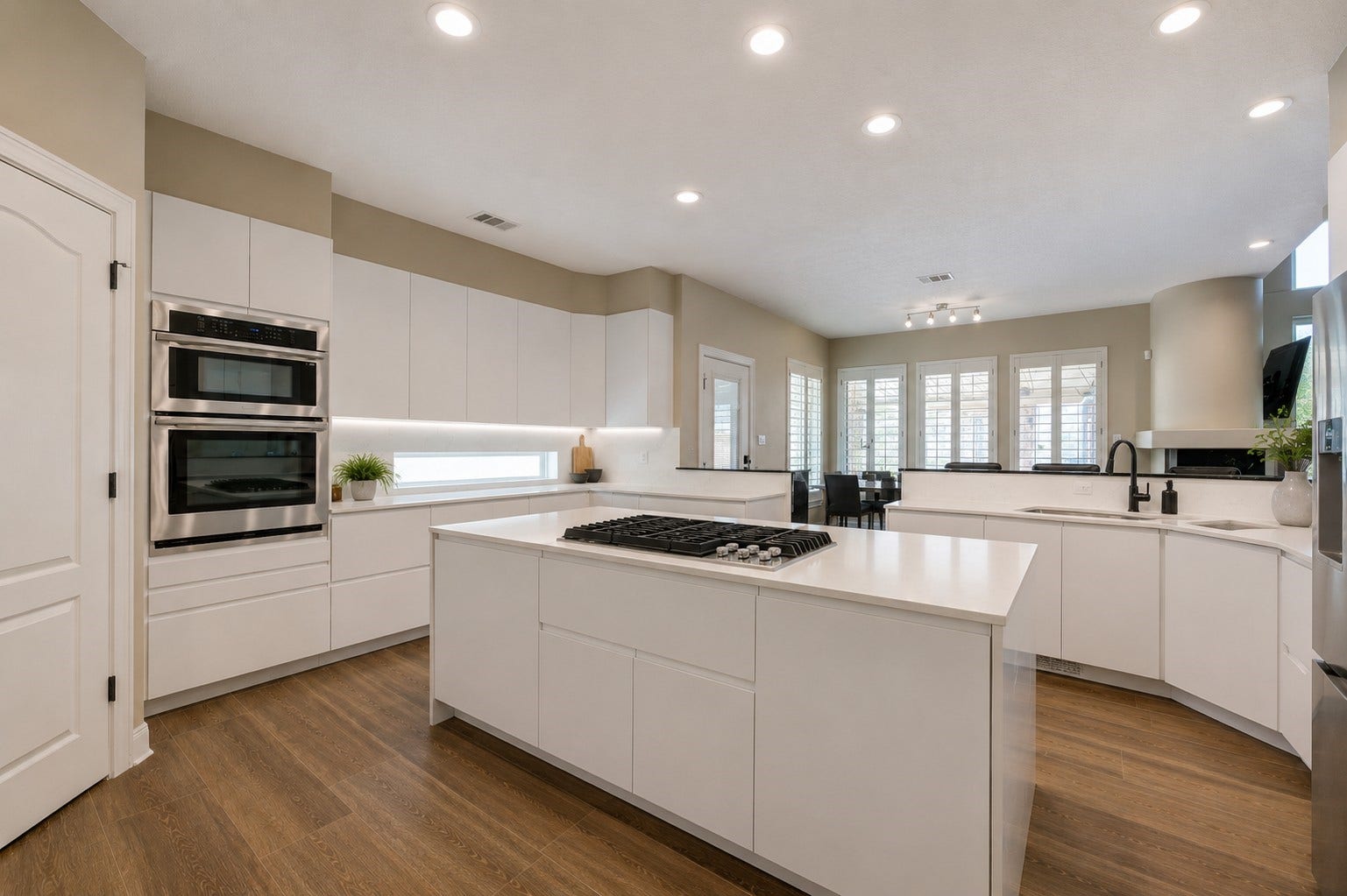 12806 Rock Falls Way, Houston, TX 77041 Discover a chef's dream kitchen featuring a central island, gas cooktop, sleek stainless steel appliances, custom white cabinetry, and ample storage.