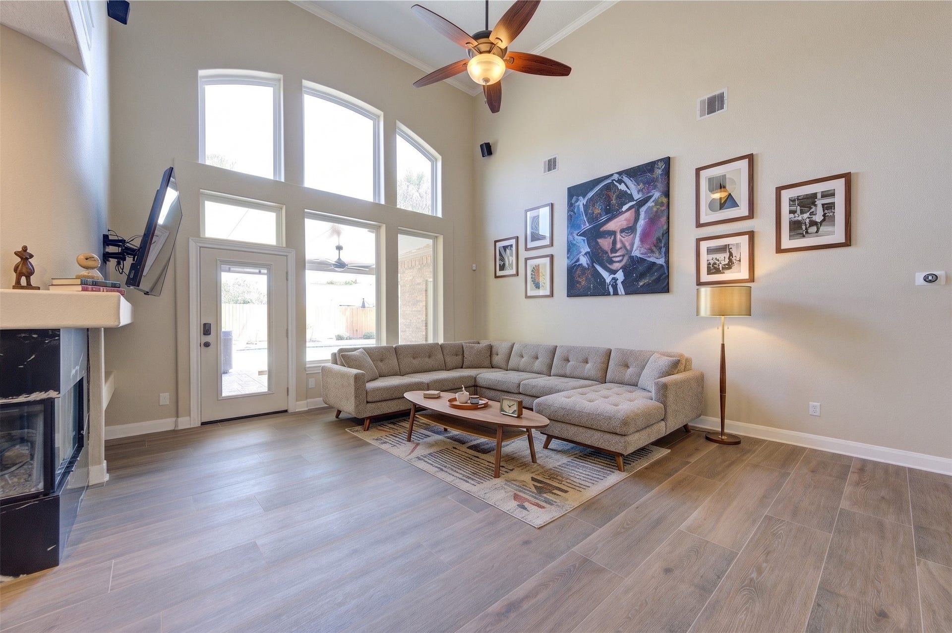 12806 Rock Falls Way, Houston, TX 77041 Bright and open living room featuring soaring high ceilings and abundant natural light. Oversized windows showcase beautiful views of the sparkling pool, creating a seamless indoor-outdoor feel perfect for relaxing or entertaining.