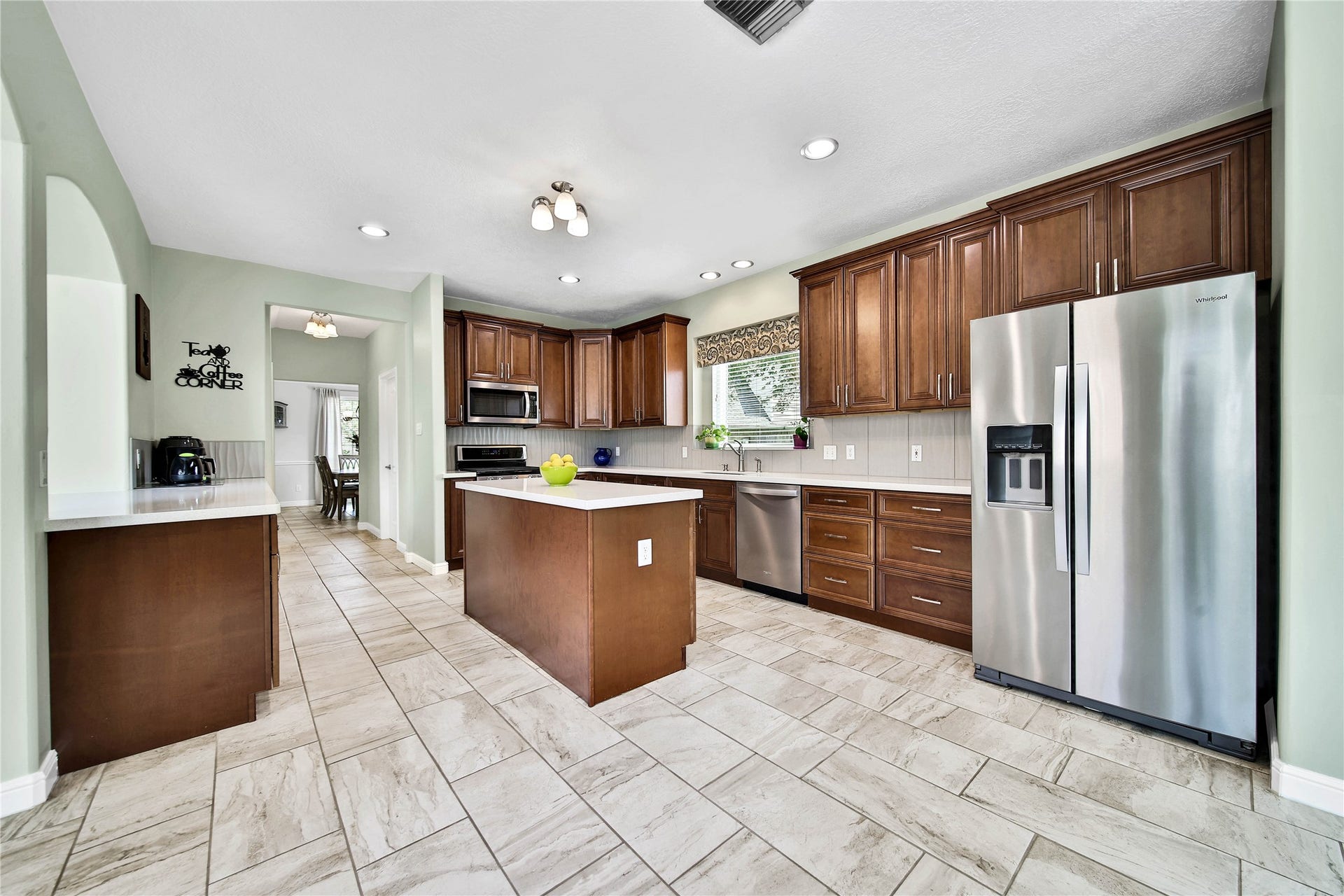 Quartz countertops grace all the counters and breakfast bar. The combination of wood and quartz makes this kitchen feel cozy and warm, but also modern and contemporary.