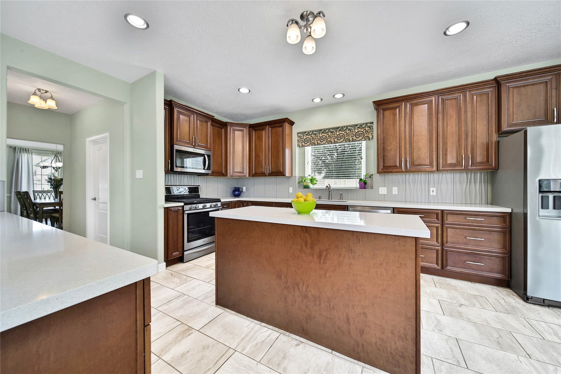 Quartz countertops grace all the counters and breakfast bar. The combination of wood and quartz makes this kitchen feel cozy and warm, but also modern and contemporary.