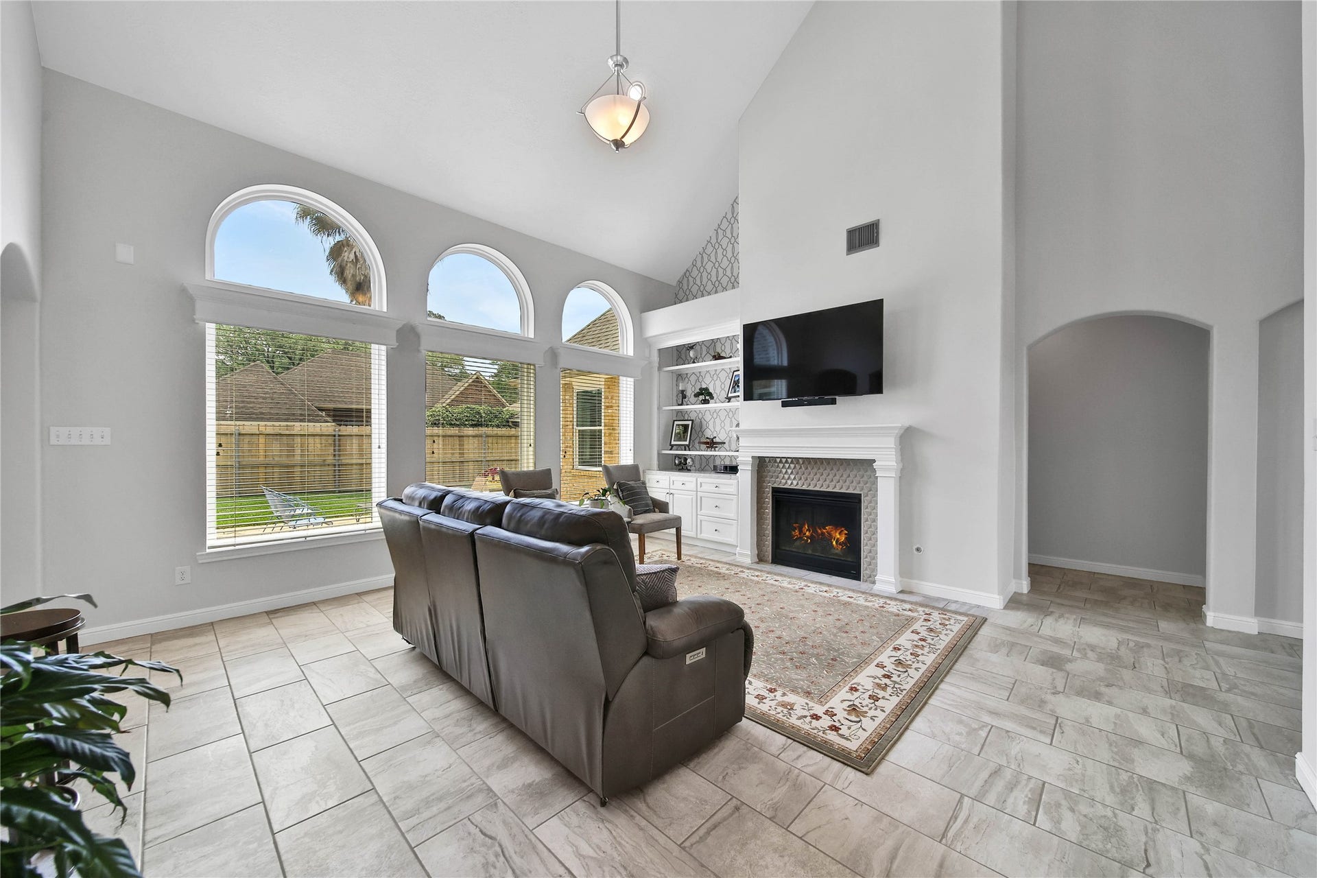 Gaslog fireplace with elegant tile surround and built in adjacent storage. Absolutely stunning and fresh feel flows throughout this home. Open to the kitchen and perfect for entertaining.