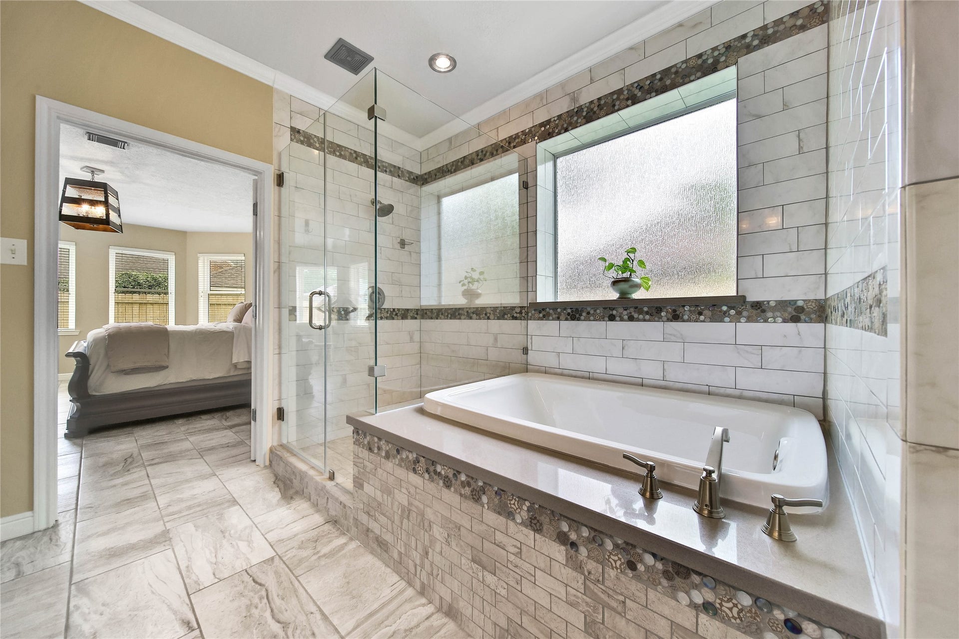 Enjoy gorgeous designer tile and finishes, oversize shower with seamless glass surround and soaker tub for relaxing!