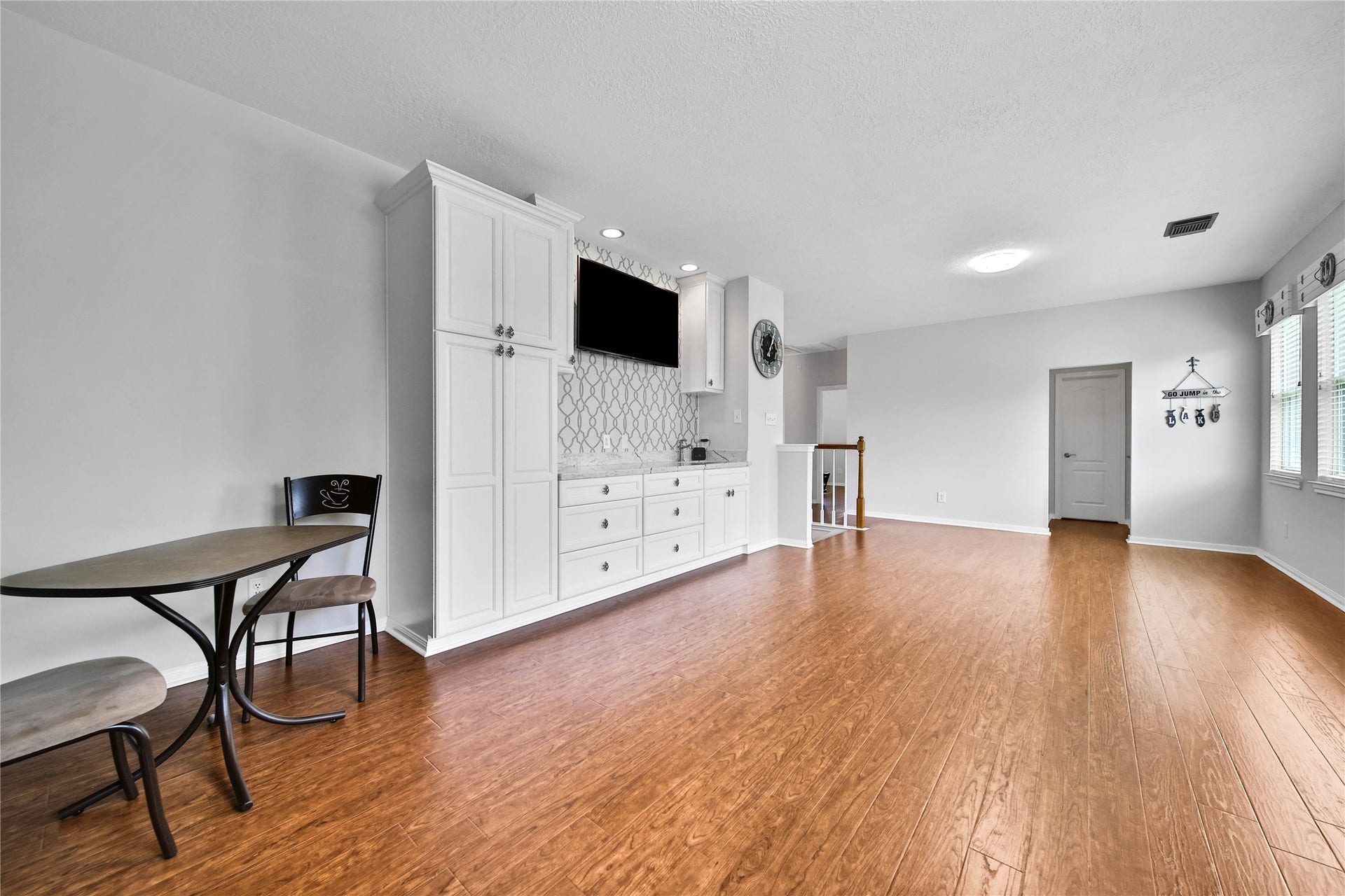 Huge Game Room upstairs with built-ins and entertainment bar. Laminate Wood-look floors flow through the upstairs.