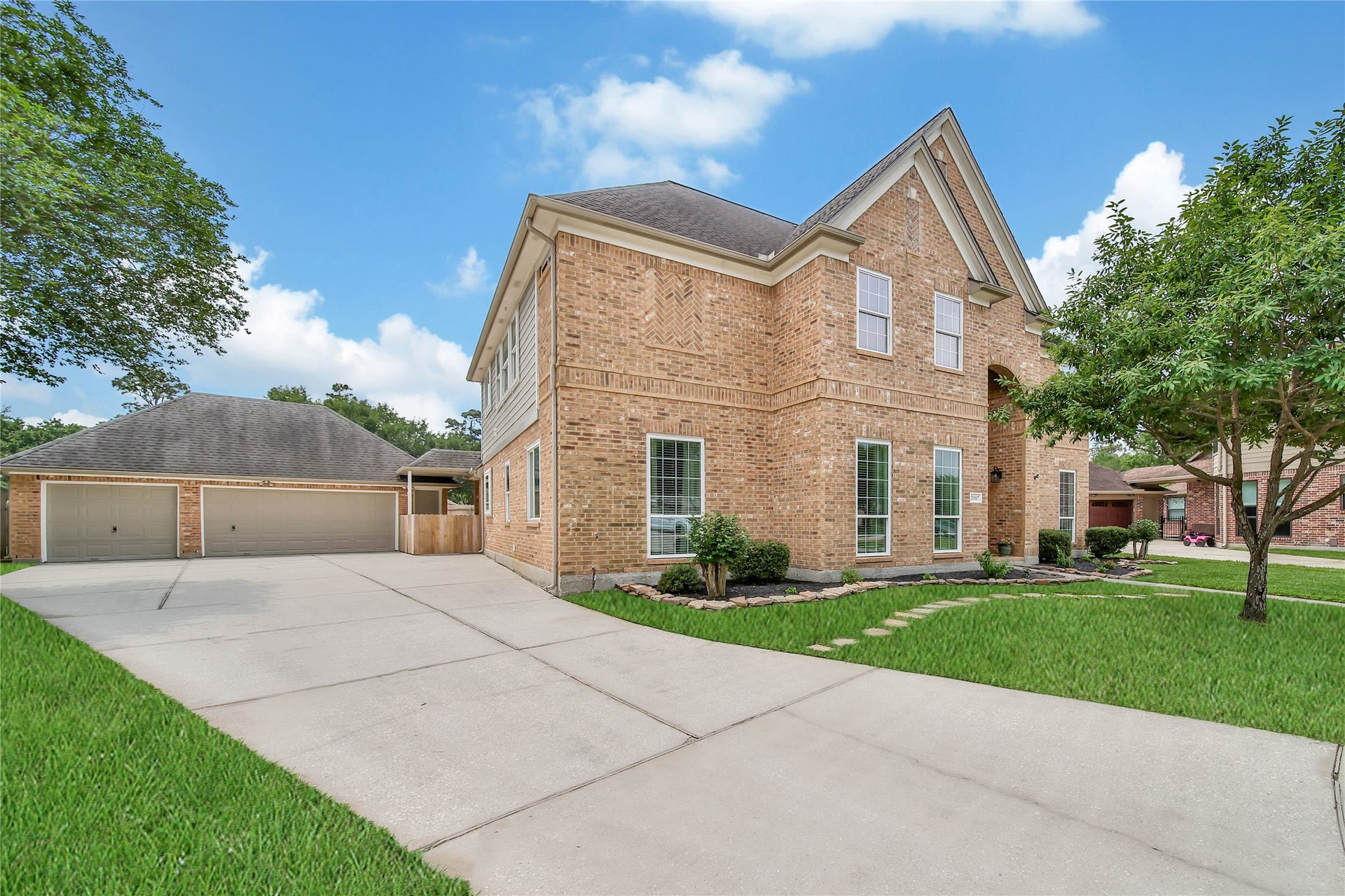 Long drive way opens to Extended 3+ car wide driveway for garage access. This 3 Car Garage is a workhorse, featuring a separate Garage features a drive-thru door into the backyard, overhead storage, and a clean up sink.  The garage is a great place to park your boat or other toys!