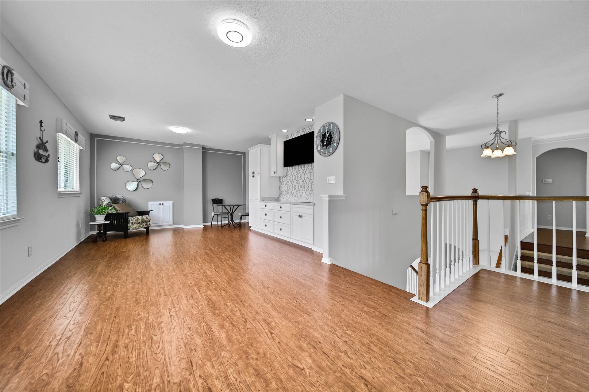 Huge Game Room upstairs with built-ins and entertainment bar. Laminate Wood-look floors flow through the upstairs.