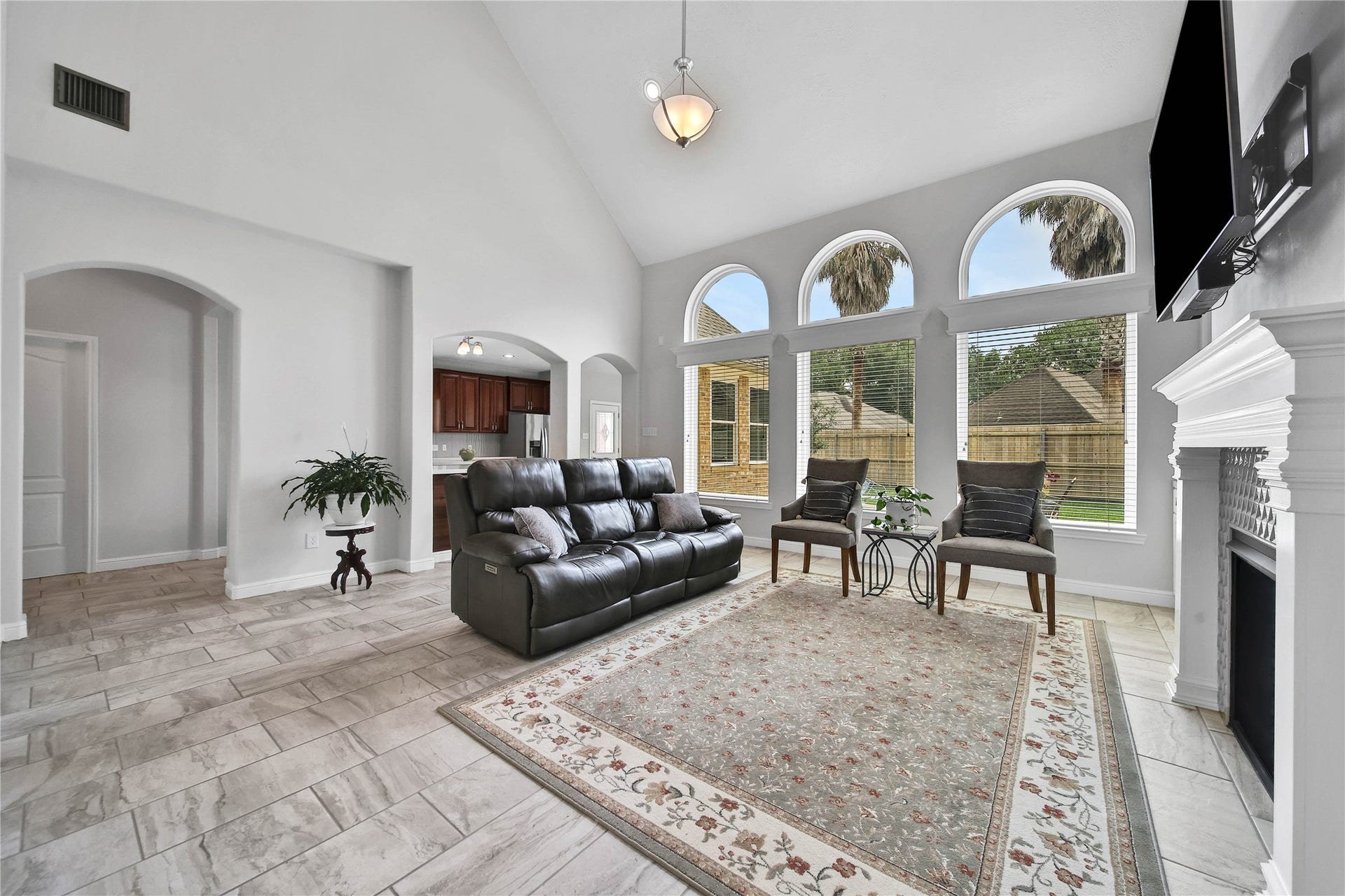 Bright and spacious living room with soaring ceiling and incredible views out top the backyard. Open to the kitchen and perfect for entertaining!
