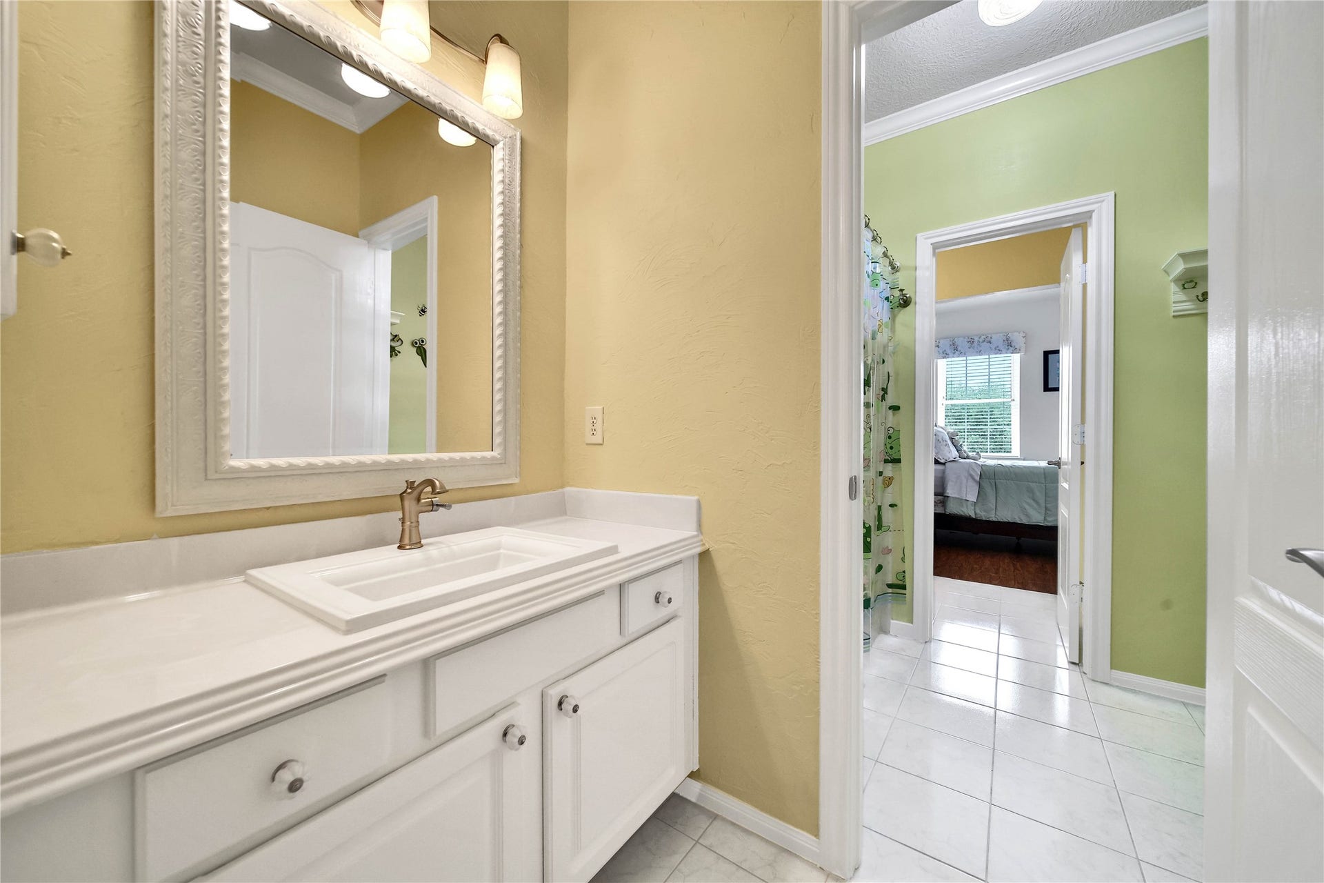 The Hollywood Bath connected to the two upstairs bedrooms is spacious and has good flow. Each separate vanity area features a large waterfall countertop with storage and drawers.