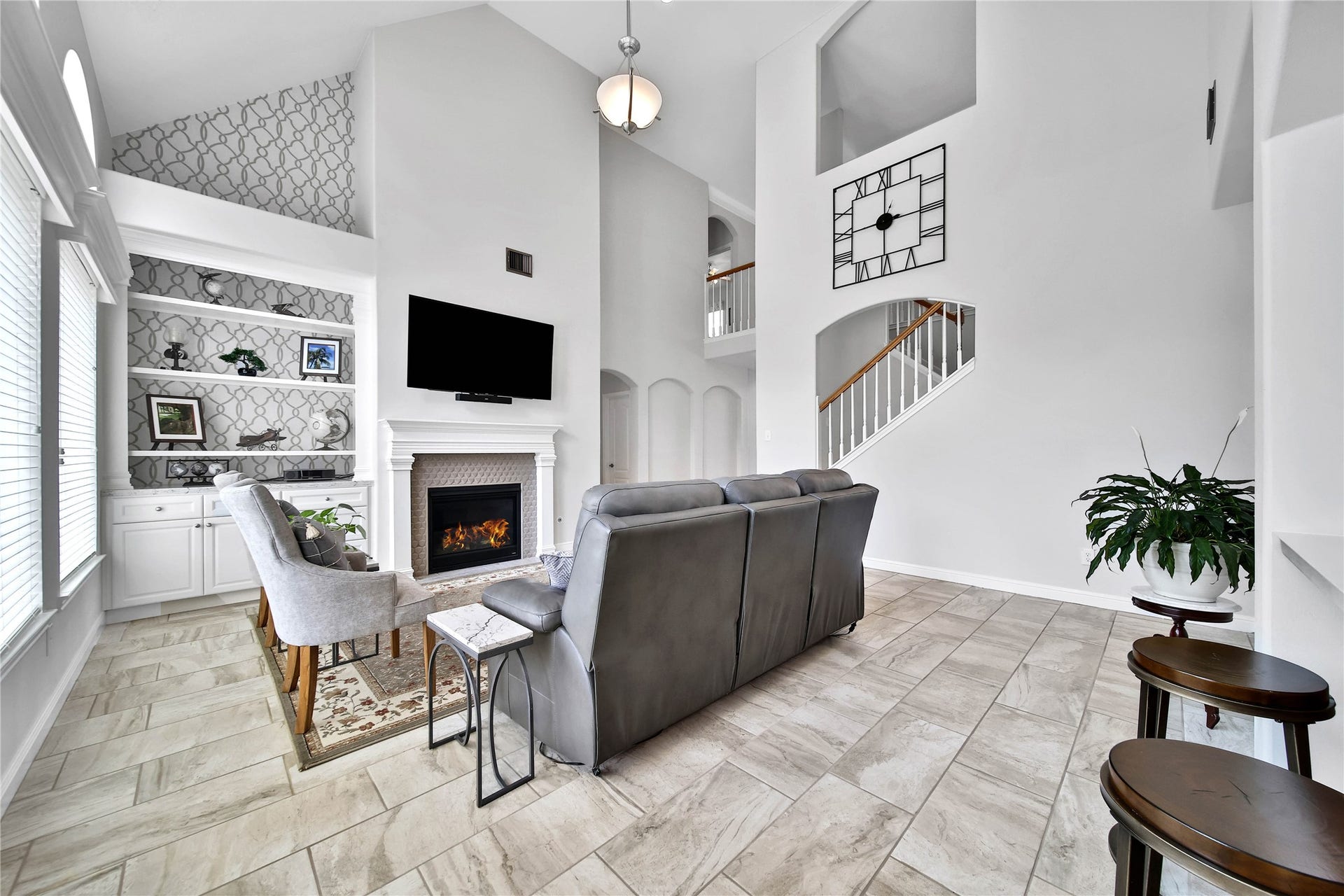 Gaslog fireplace with elegant tile surround and built in adjacent storage. Absolutely stunning and fresh feel flows throughout this home. Open to the kitchen and perfect for entertaining.