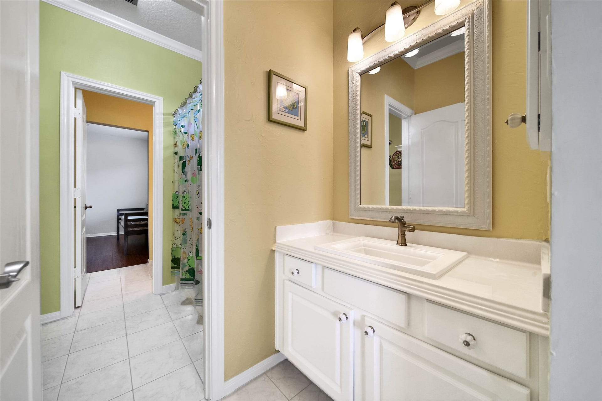 The Hollywood Bath connected to the two upstairs bedrooms is spacious and has good flow. Each separate vanity area features a large waterfall countertop with storage and drawers.
