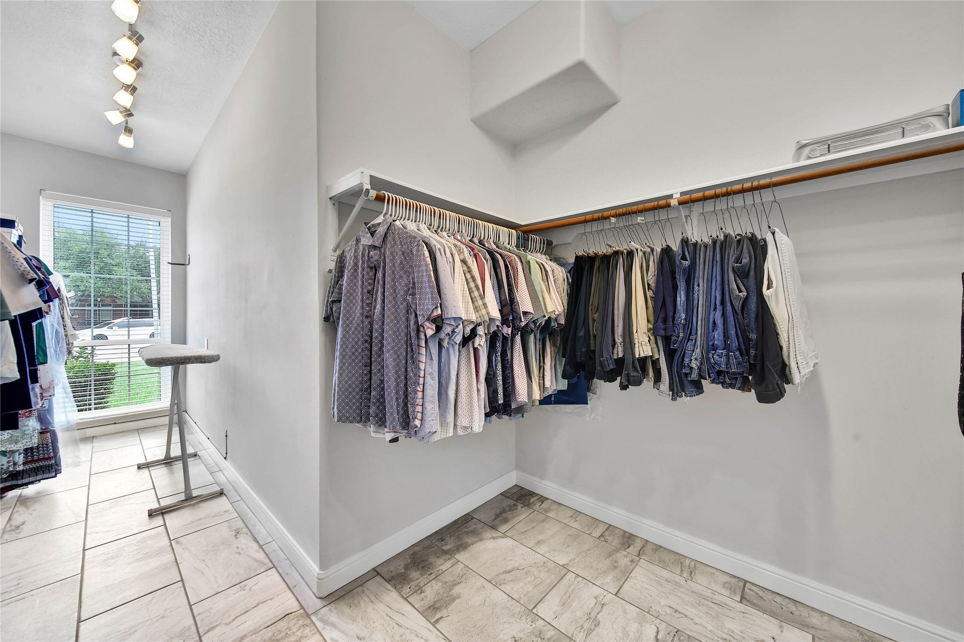 This HUGE primary closet and dressing room is located off the en-suite bath in the primary bedroom. SOOO much room in here!