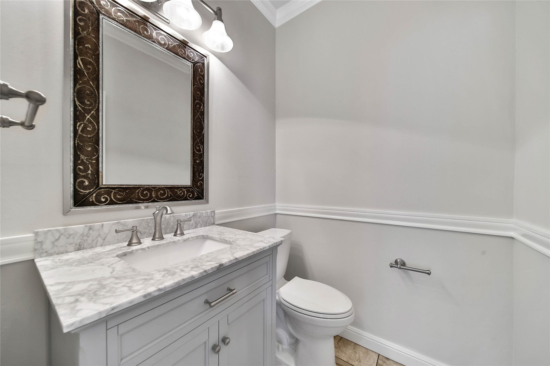 Elegant half bath located downstairs, with neutral paint and custom vanity and updated finishes, hardware and countertop.