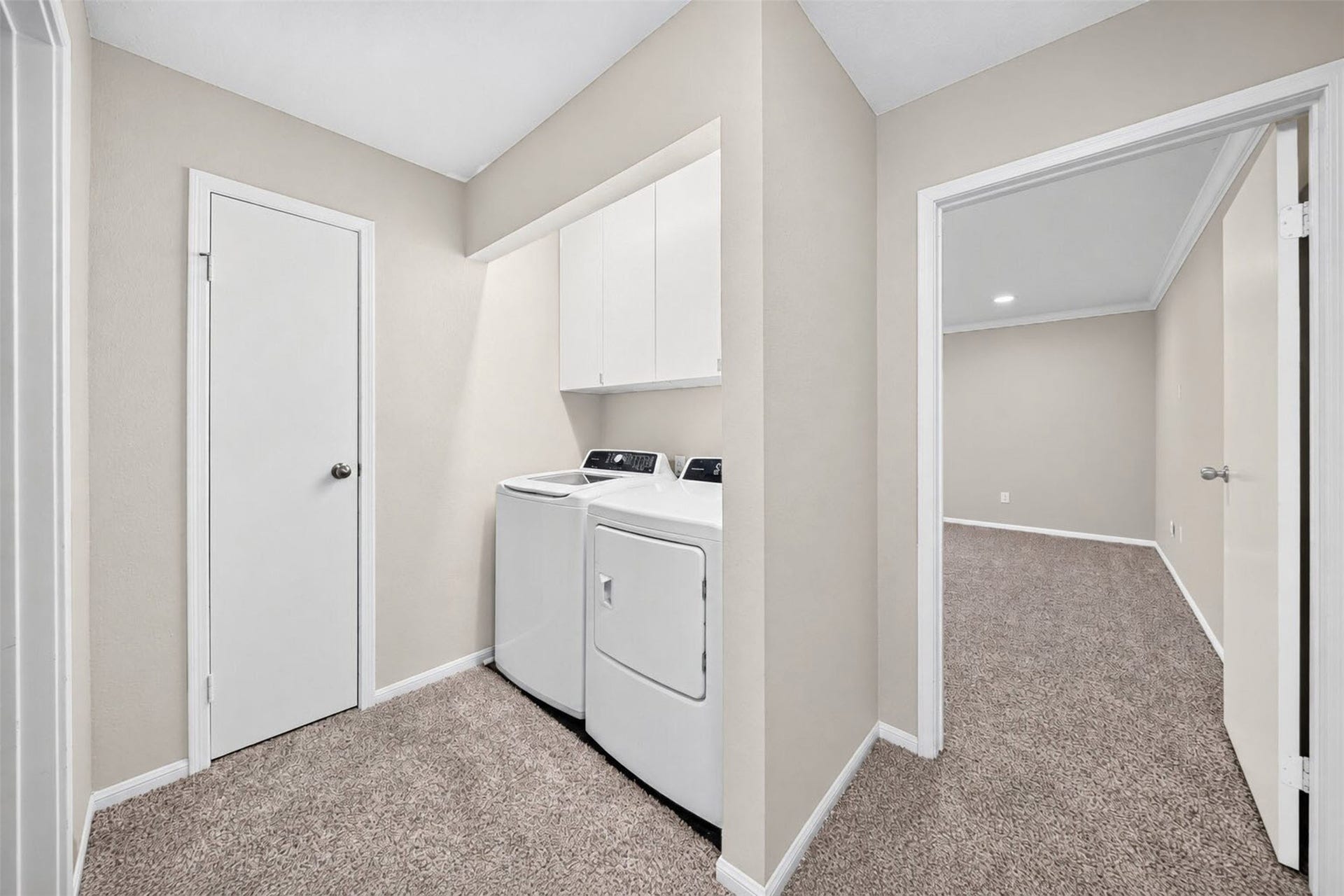 2379 Briarwest Boulevard, #85, Houston, TX 77077 Laundry lives upstairs in its own nook with a full-size washer and dryer and cabinets above for supplies, just outside the second bedroom.