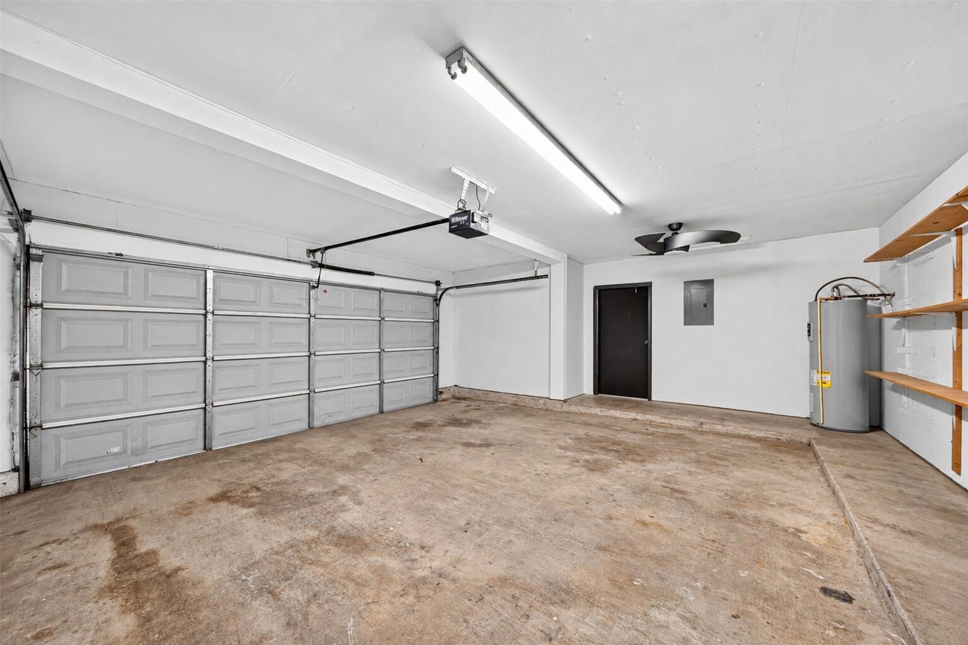 2379 Briarwest Boulevard, #85, Houston, TX 77077 The oversized two-car garage features an automatic opener, built-in wood shelving, a ceiling fan, and room for the water heater plus storage.
