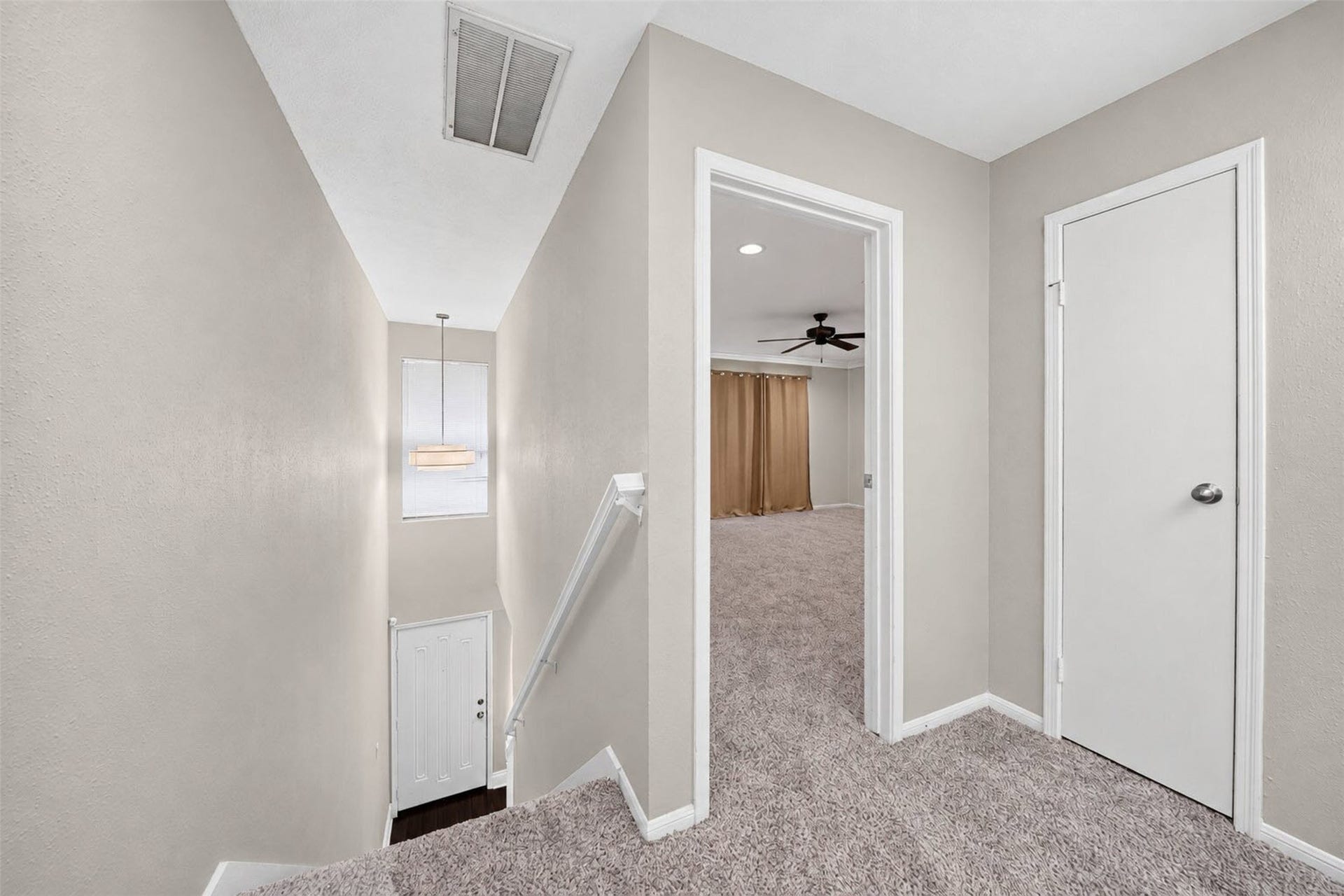 2379 Briarwest Boulevard, #85, Houston, TX 77077 The carpeted upstairs landing overlooks the entry stairwell and front door below, and opens into the primary bedroom.