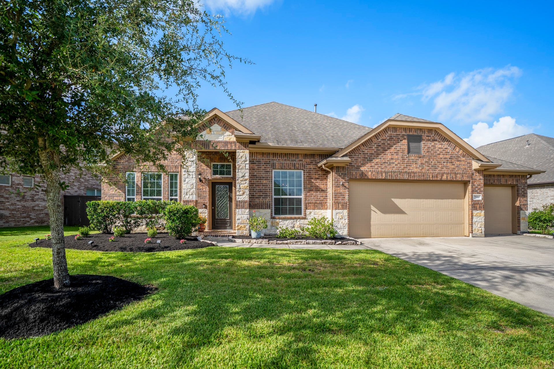 7511 Laguna Lake Drive, Spring, TX 77379 Welcome to 7511 Laguna Lake Drive, where a brick-and-stone exterior, landscaped beds, and a shade tree create a warm first look from the curb.