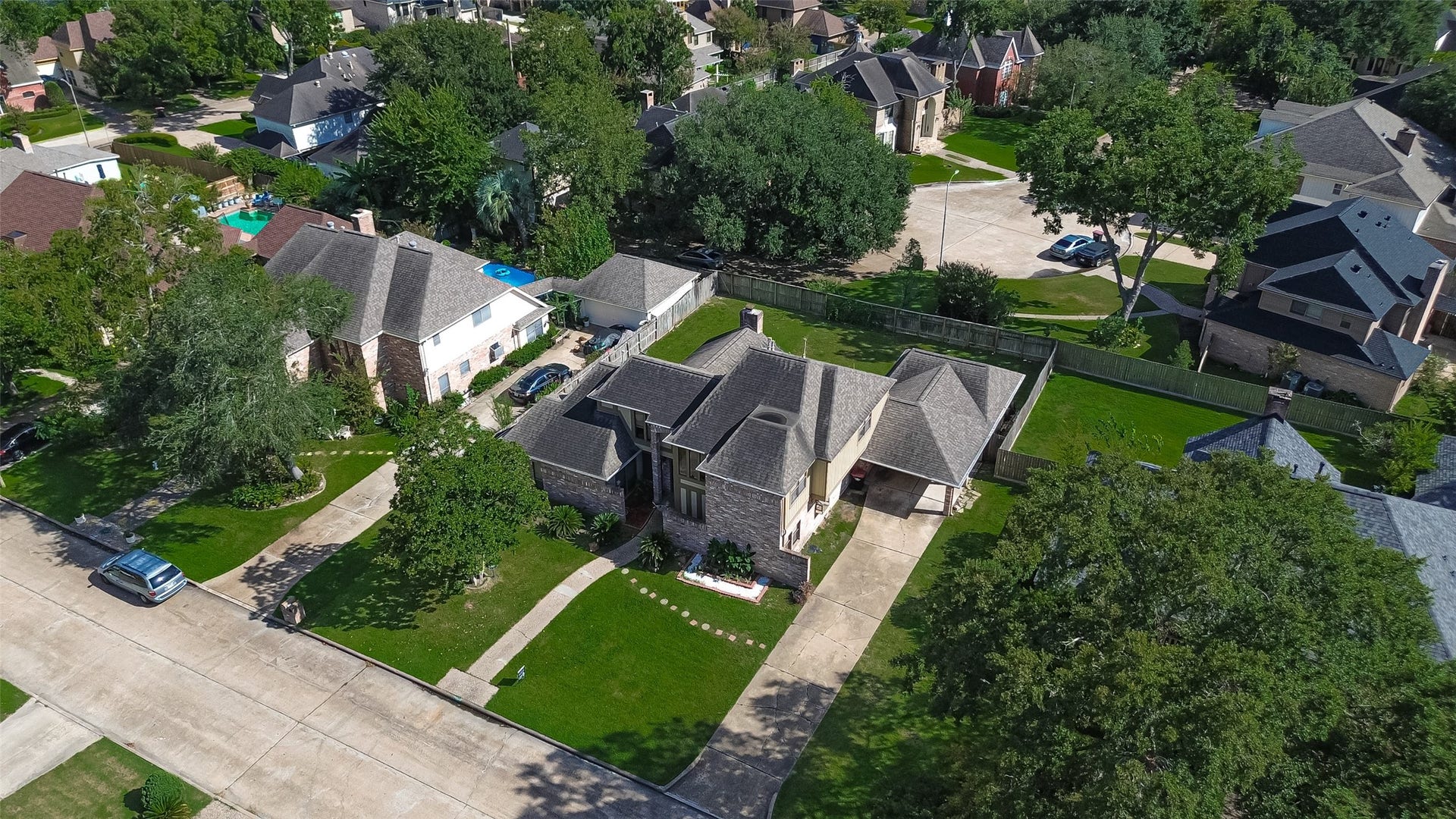 14819 Alderwick Drive, Sugar Land, TX 77498 An elevated perspective reveals the homes placement within the neighborhood, with its sweeping driveway and surrounding properties on display.