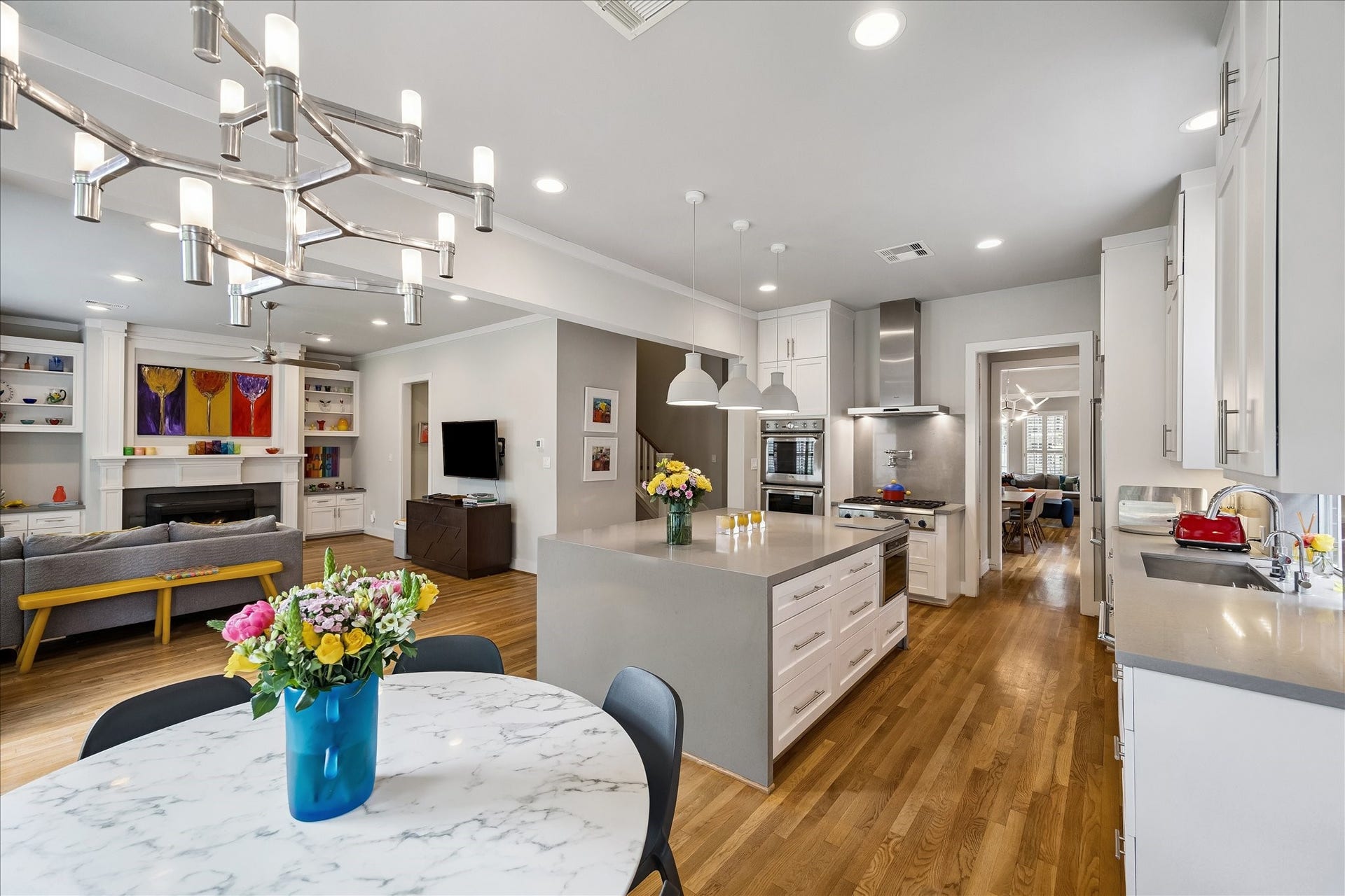 From this angle, underneath the 12-light chrome chandelier in the breakfast room, you are able to appreciate the open floor plan at 2514 McClendon.