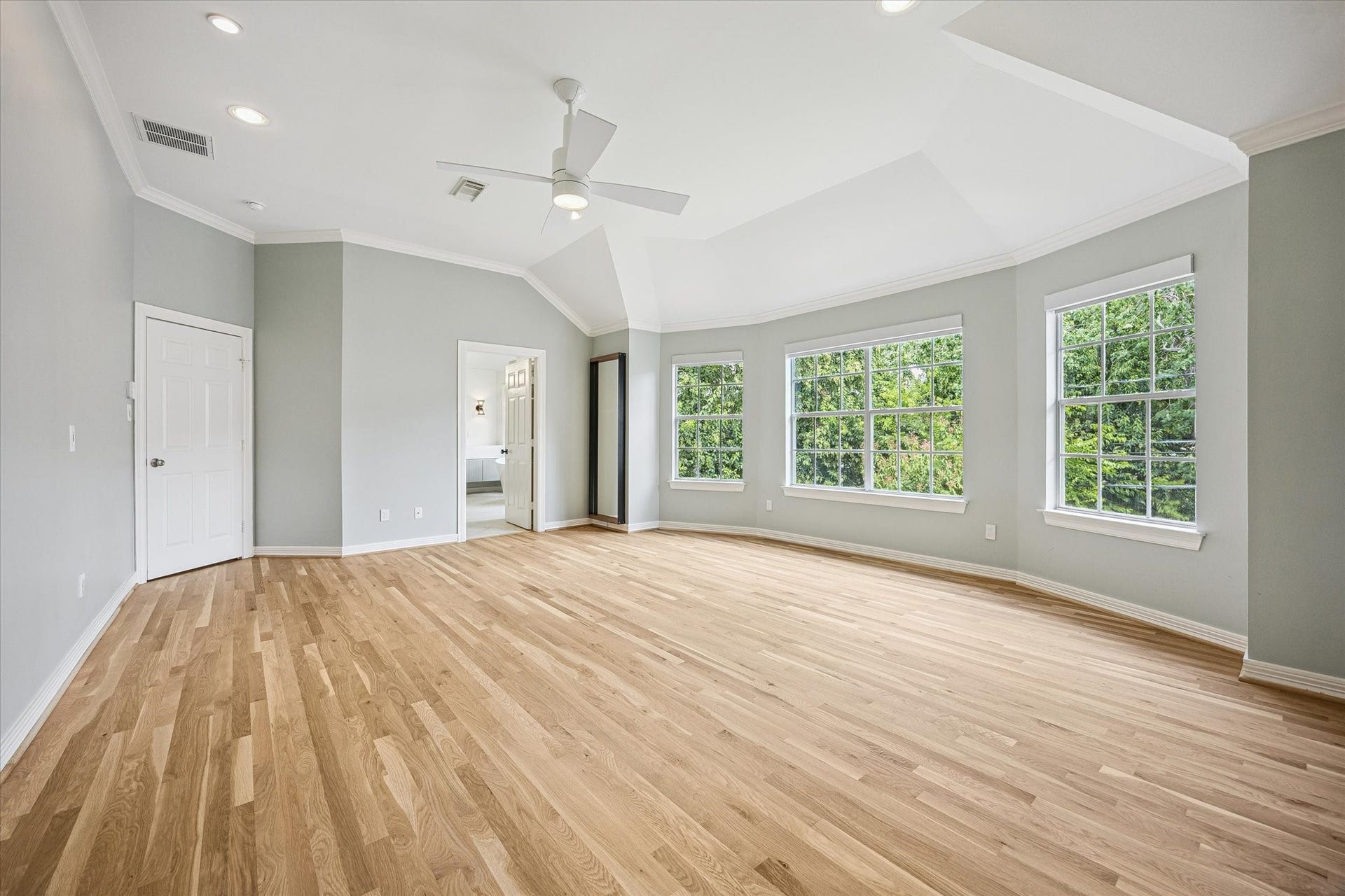 The door in center frame leads to the spa-like bathroom.  Each of the bedrooms, hallways and flex rooms on the second floor have brand new hardwoods floors installed in the summer of 2026.