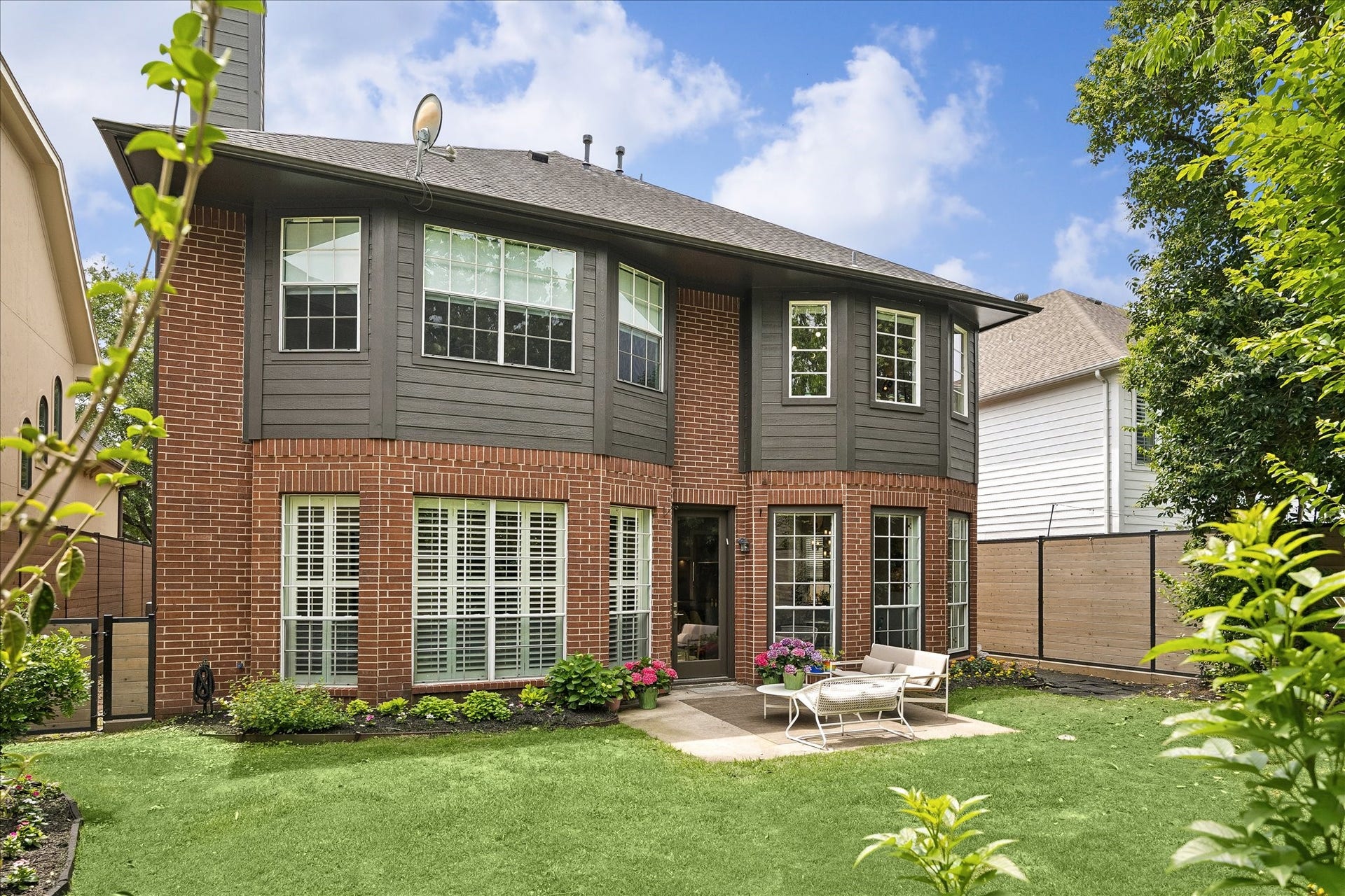 Here is another view of the large backyard with a view of the rear elevation of this all brick & cement board home.