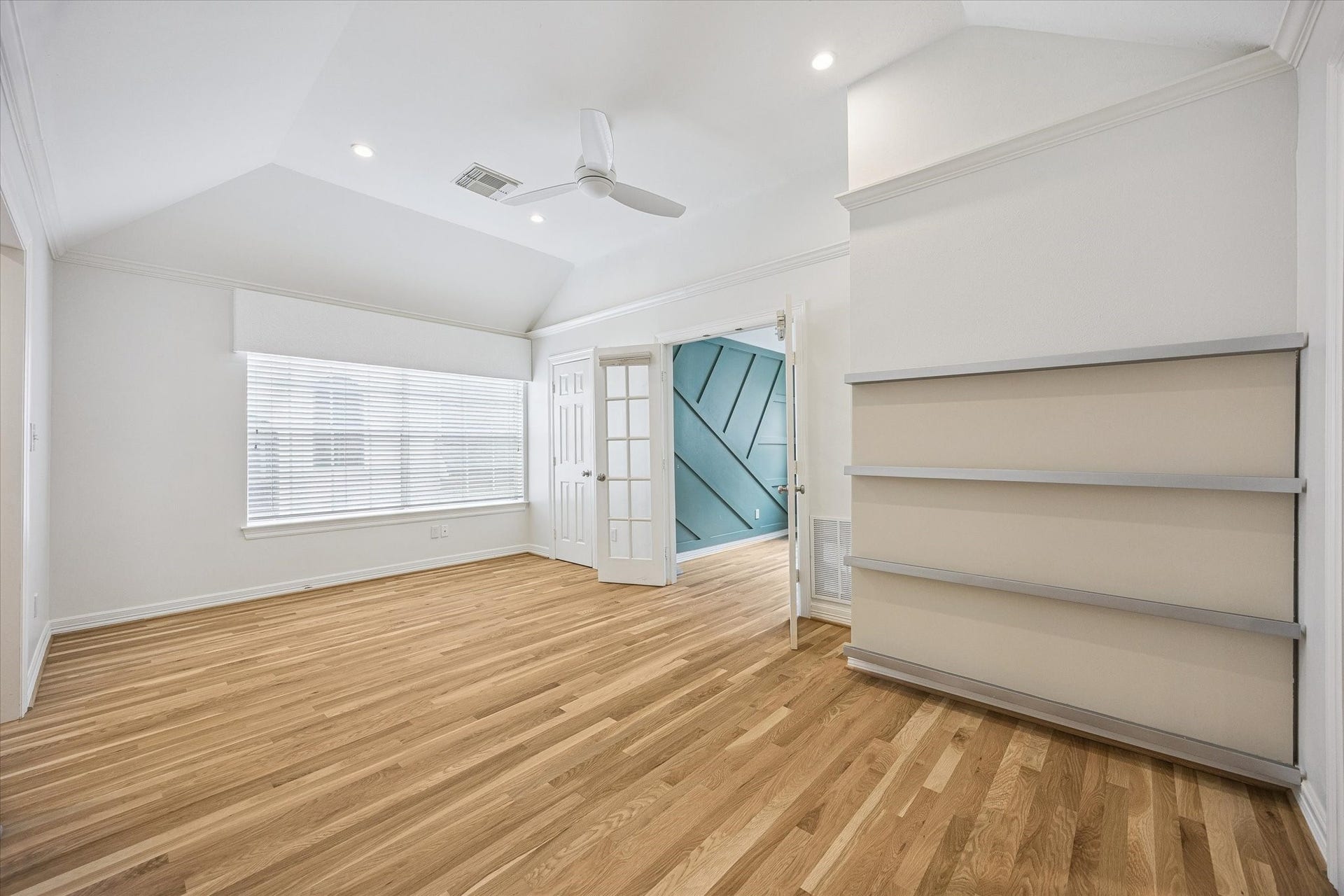 The French doors open to the first of three secondary bedrooms.