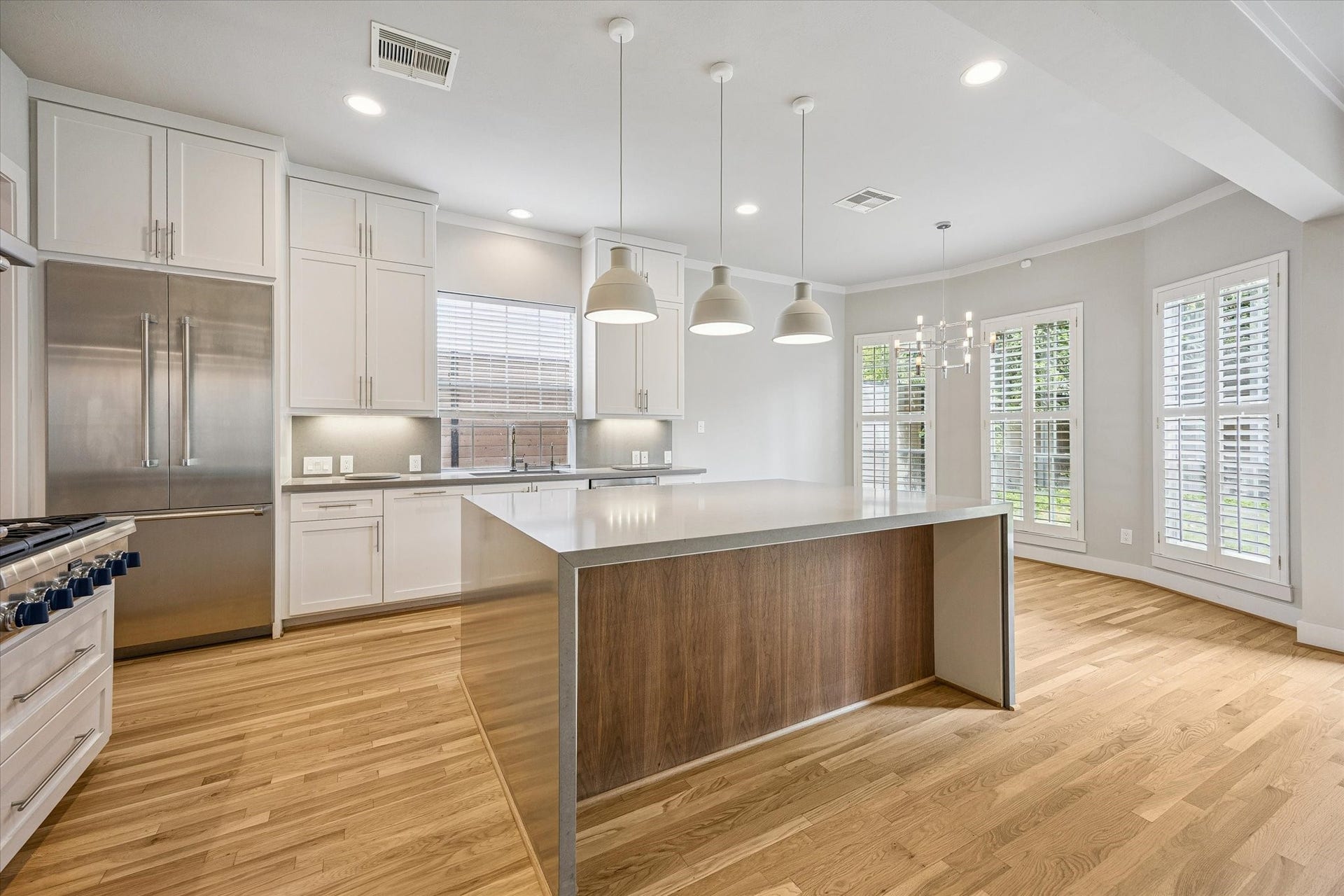 The kitchen has an oversized, 'Fresh Concrete' waterfall island by Caesarstone.