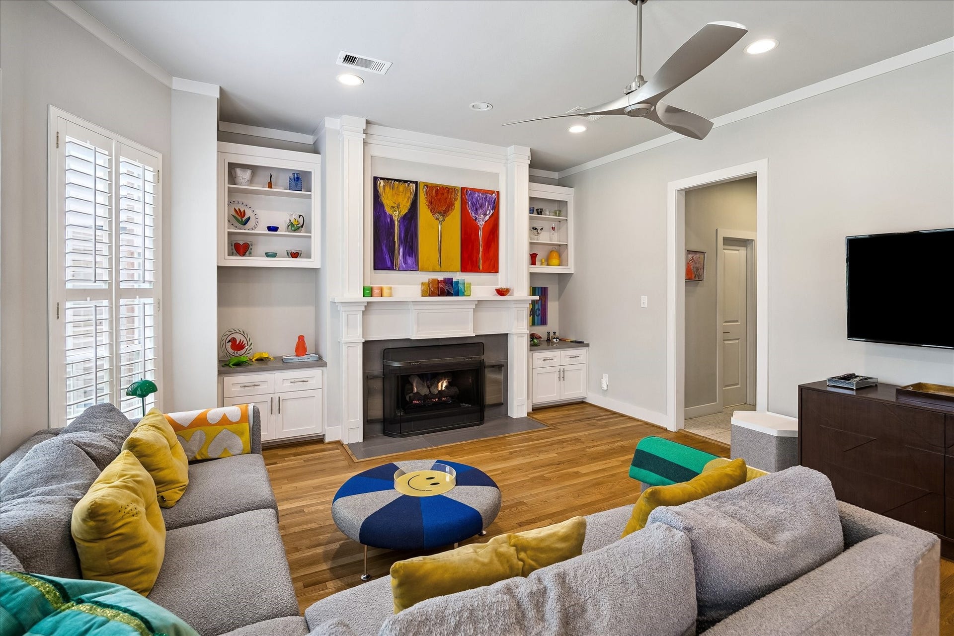 Here is another angle of the family room with a cased opening that leads to the downstairs powder bath servicing the first floor.