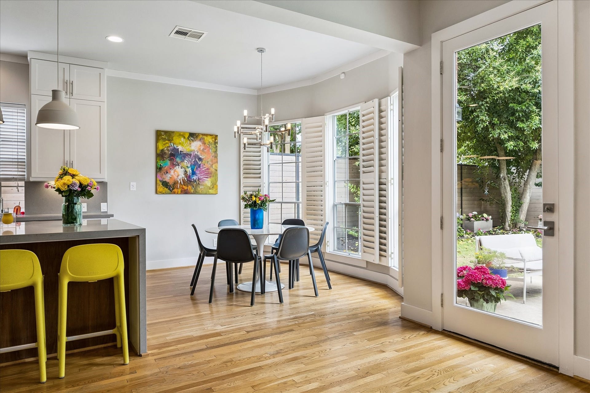 A glass door aligned in the center of the home provides ingress/egress to the oversized backyard.