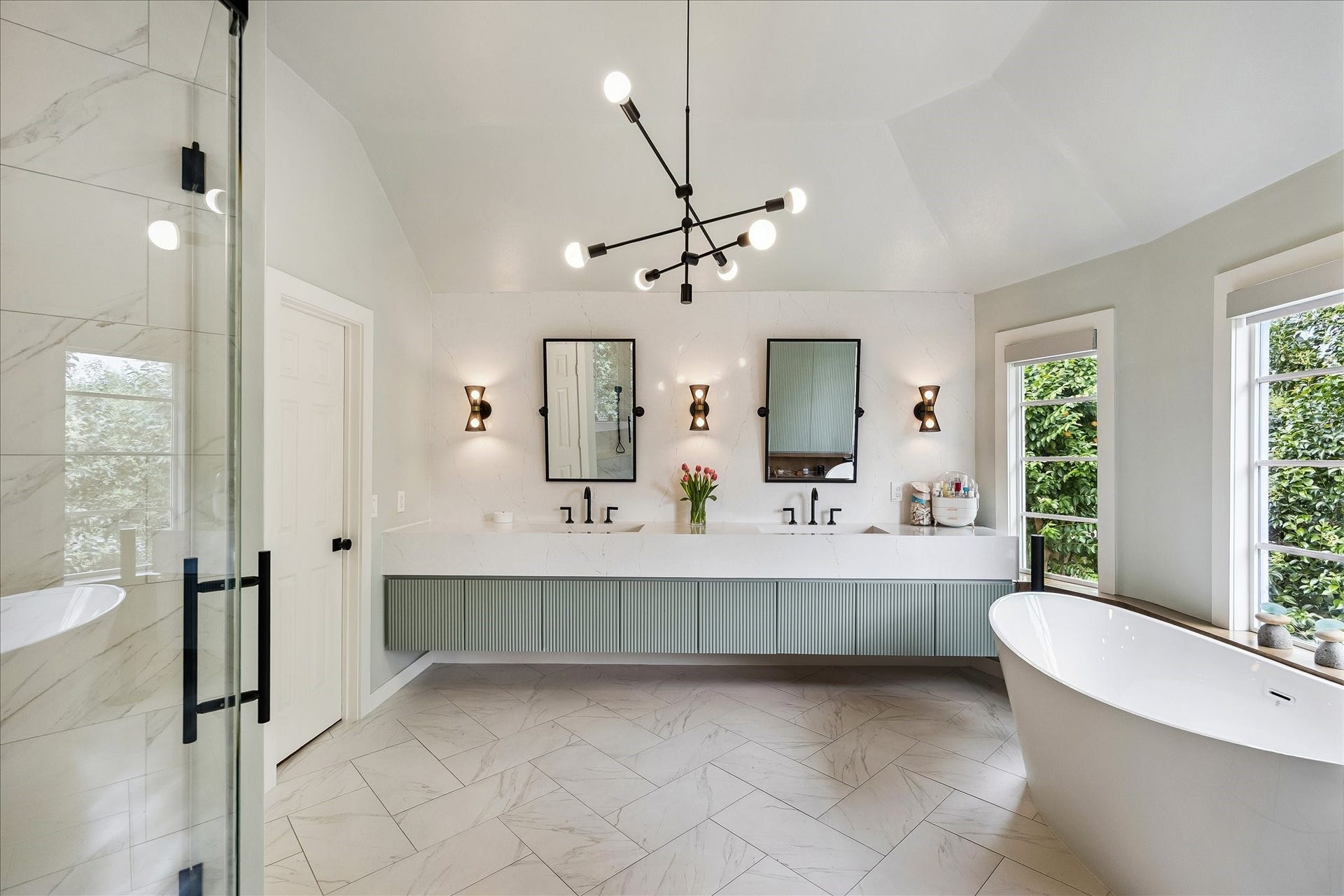 Updated and elevated with designer finishes such as Brizo plumbing fixtures, this bathroom feature a floating vanity with a soothing hue of paint.