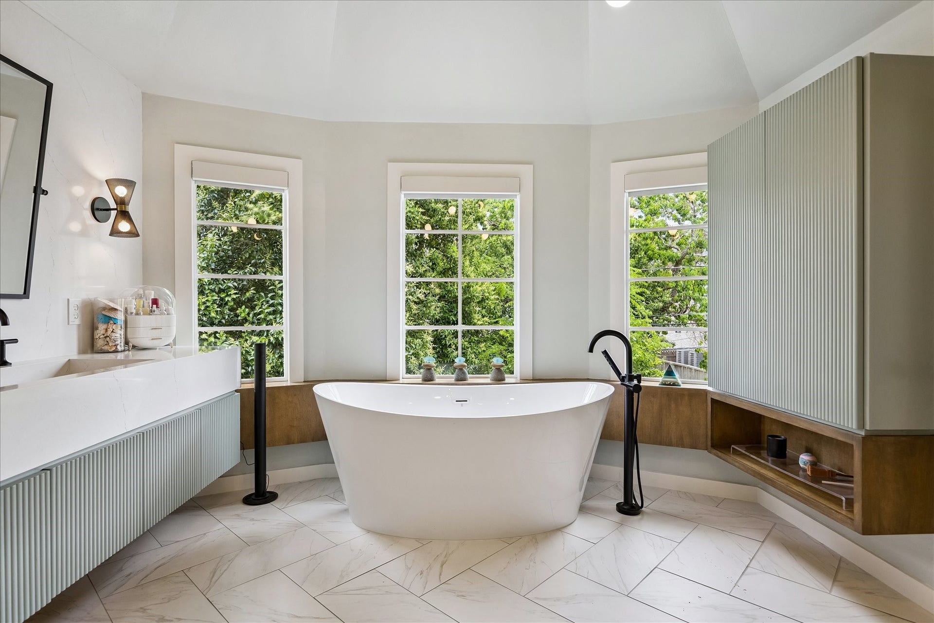 Here is another view of the master bath with its breathtaking soaking tub framed underneath a wall of windows making it feel like you are in the middle of a treehouse.  Not photographed is a separate water closet with custom washlet.