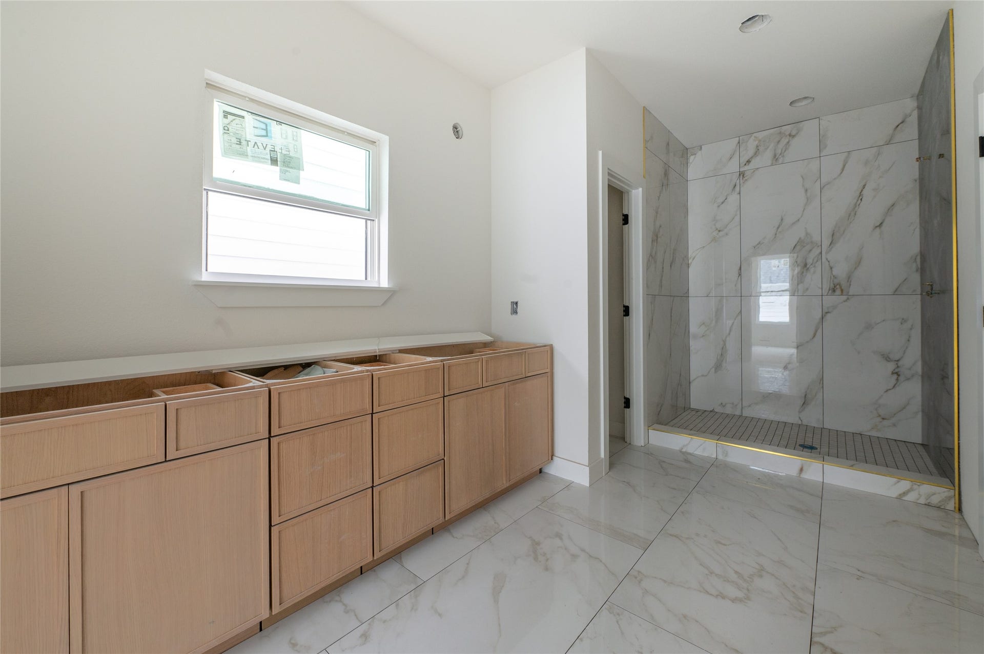 Primary bathroom with slim shaker cabinets, double sinks, and stand alone shower.