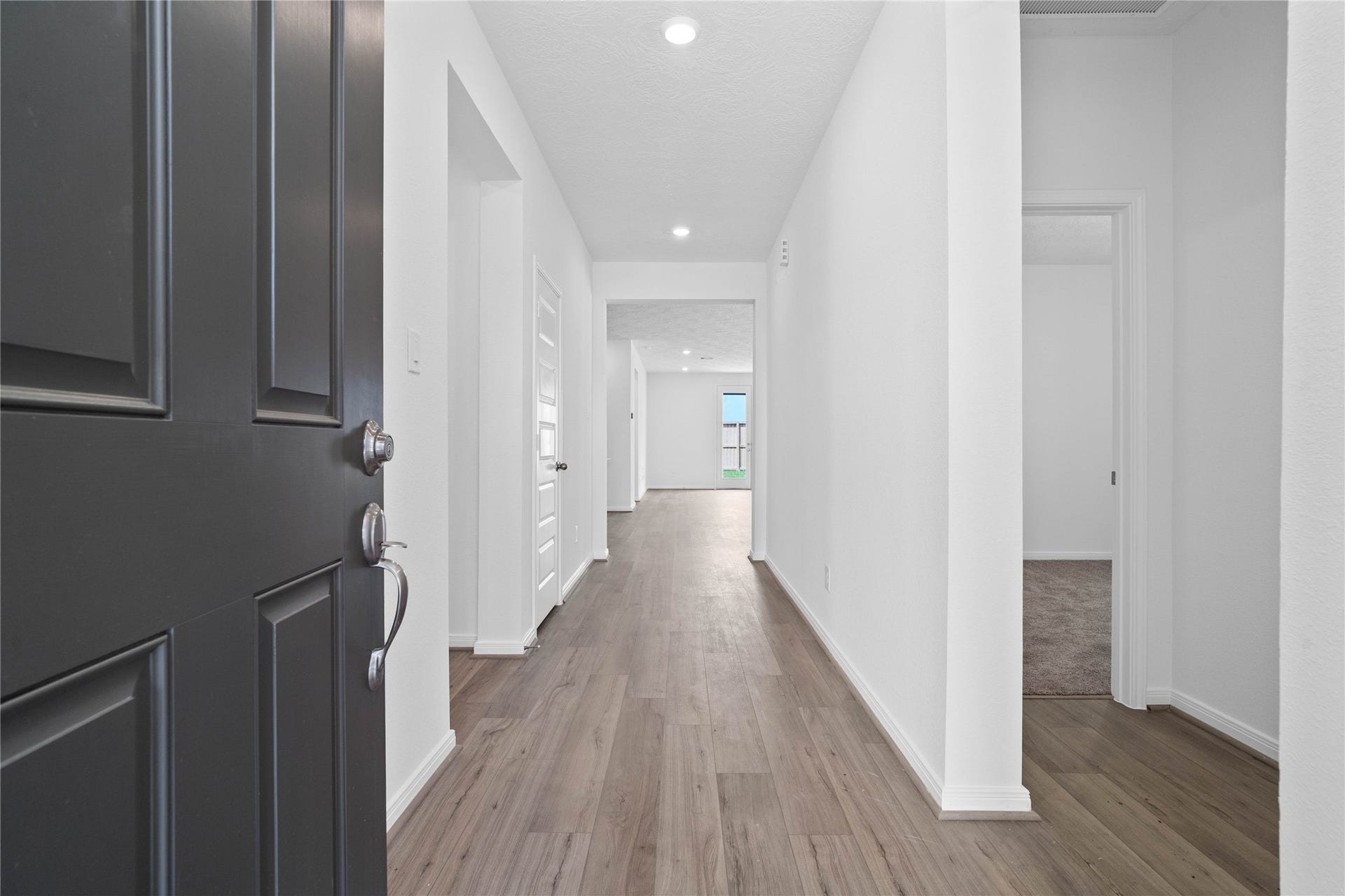Welcome inside this lovely home of 12819 Autumn Woods! Upon entering you find a lovely corridor showcasing custom paint, beautiful Layton Lake vinyl plank floors, modern archways, high ceilings, and ample lighting!