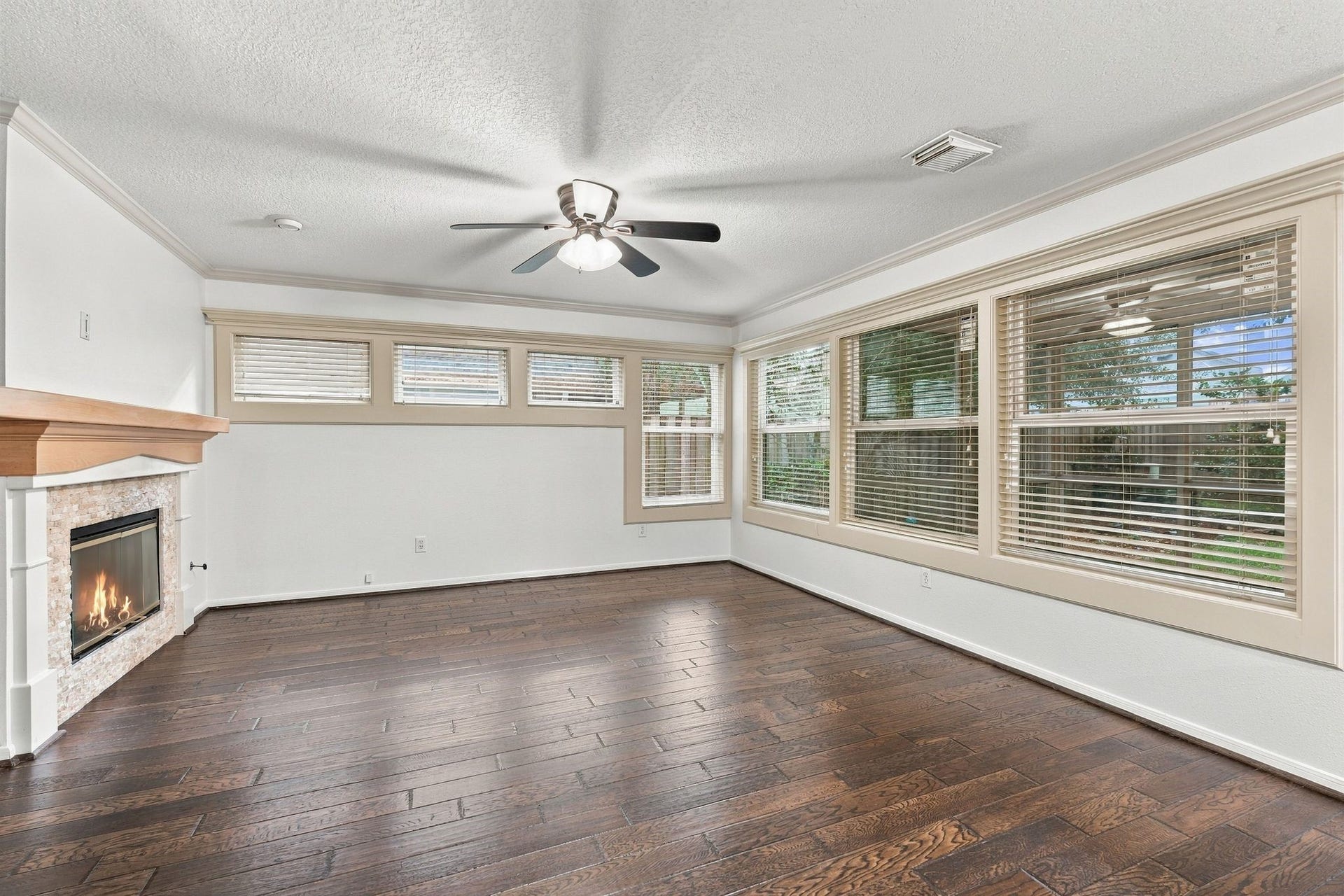 202 W Greywing Circle, The Woodlands, TX 77382 Natural light from the large windows leading to screened in patio