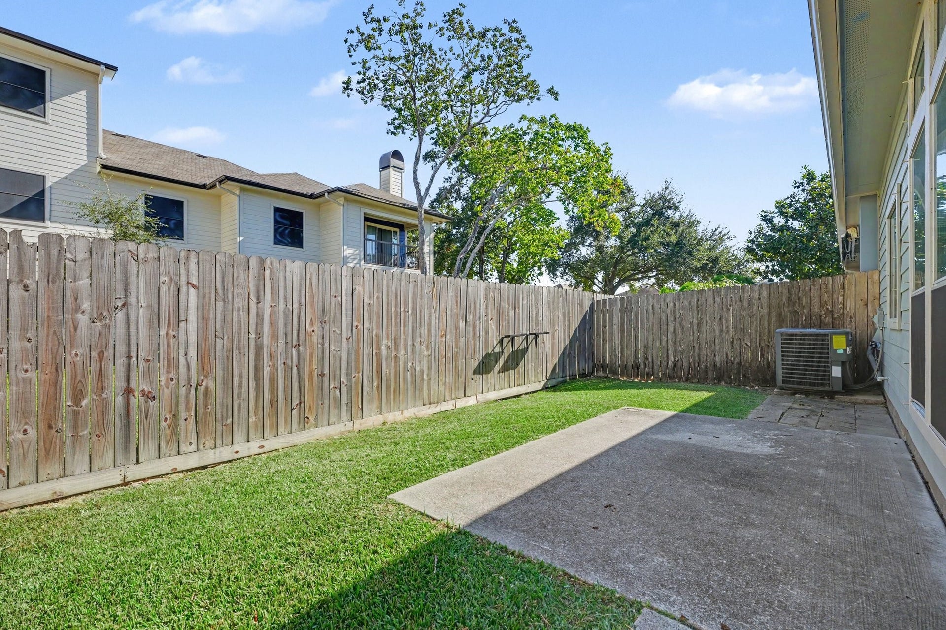 2804 Sand Dune Drive, Seabrook, TX 77586 Fenced in backyard featuring a patio area and wraparound green space.
