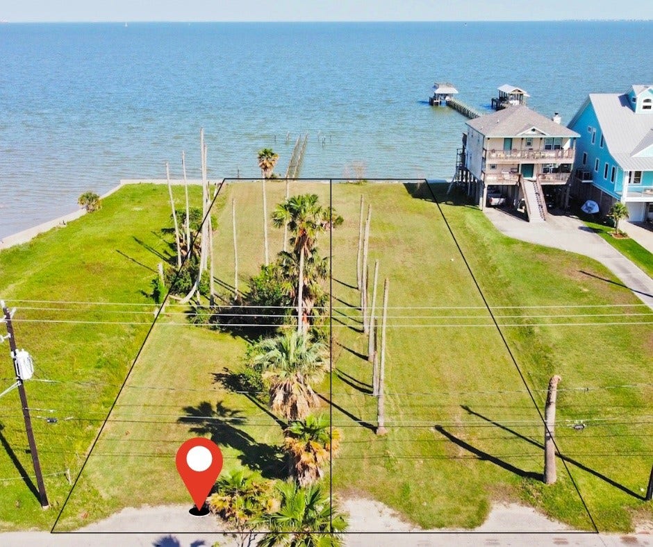 1818 - 1820 Todville Road, Seabrook, TX 77586 Waterfront property with a clear view of the ocean, framed by palm trees. The lots are spacious and flat, located between two houses, with a pier nearby. Ideal for building a coastal home with direct water access. 1818 &1820 on the left side.