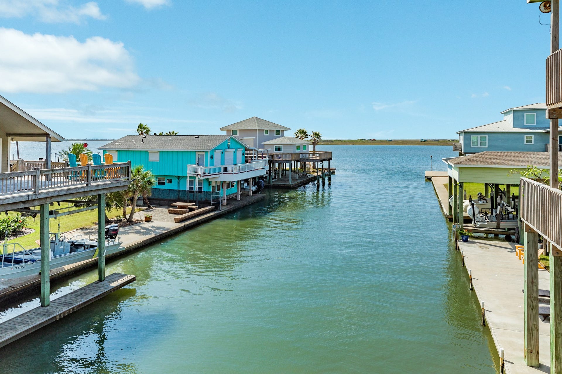 Beautiful views down the canal toward the expansive bay showcase the property's waterfront setting and surrounding coastal homes.
