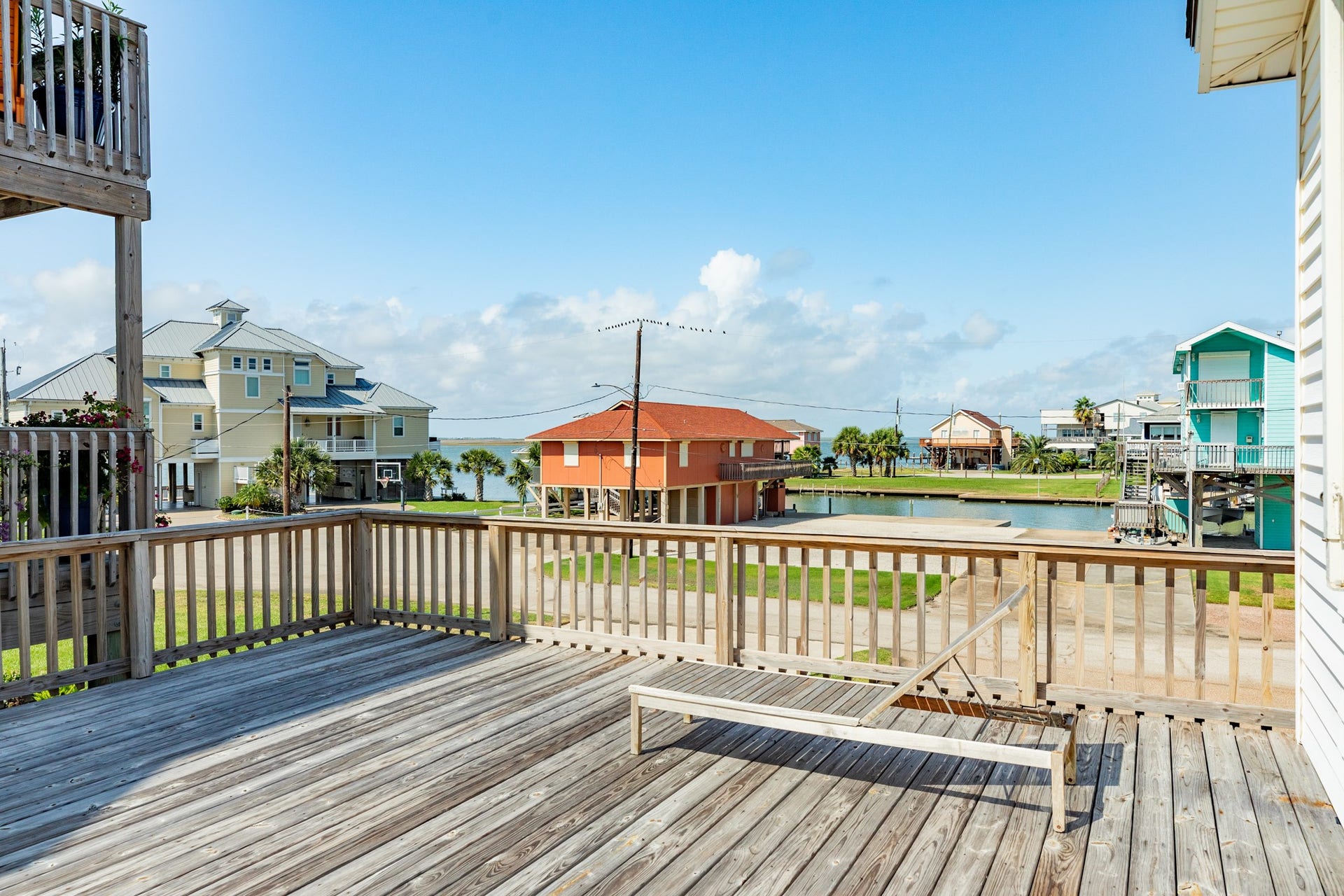 Enjoy neighborhood and waterway views from this generous elevated deck, offering an additional outdoor space for relaxing in the sunshine.