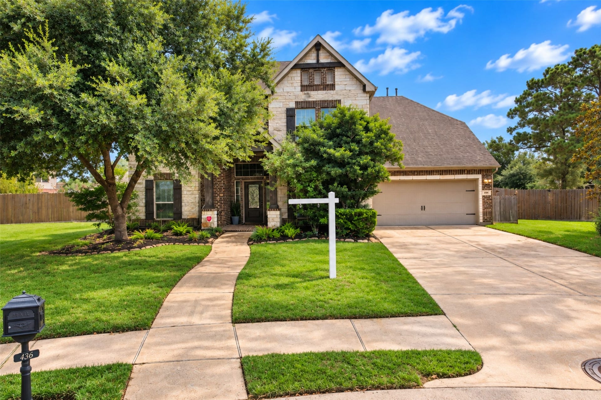 436 Old Orchard Court, Dickinson, TX 77539 Brick and stone elevation with mature trees and wide driveway