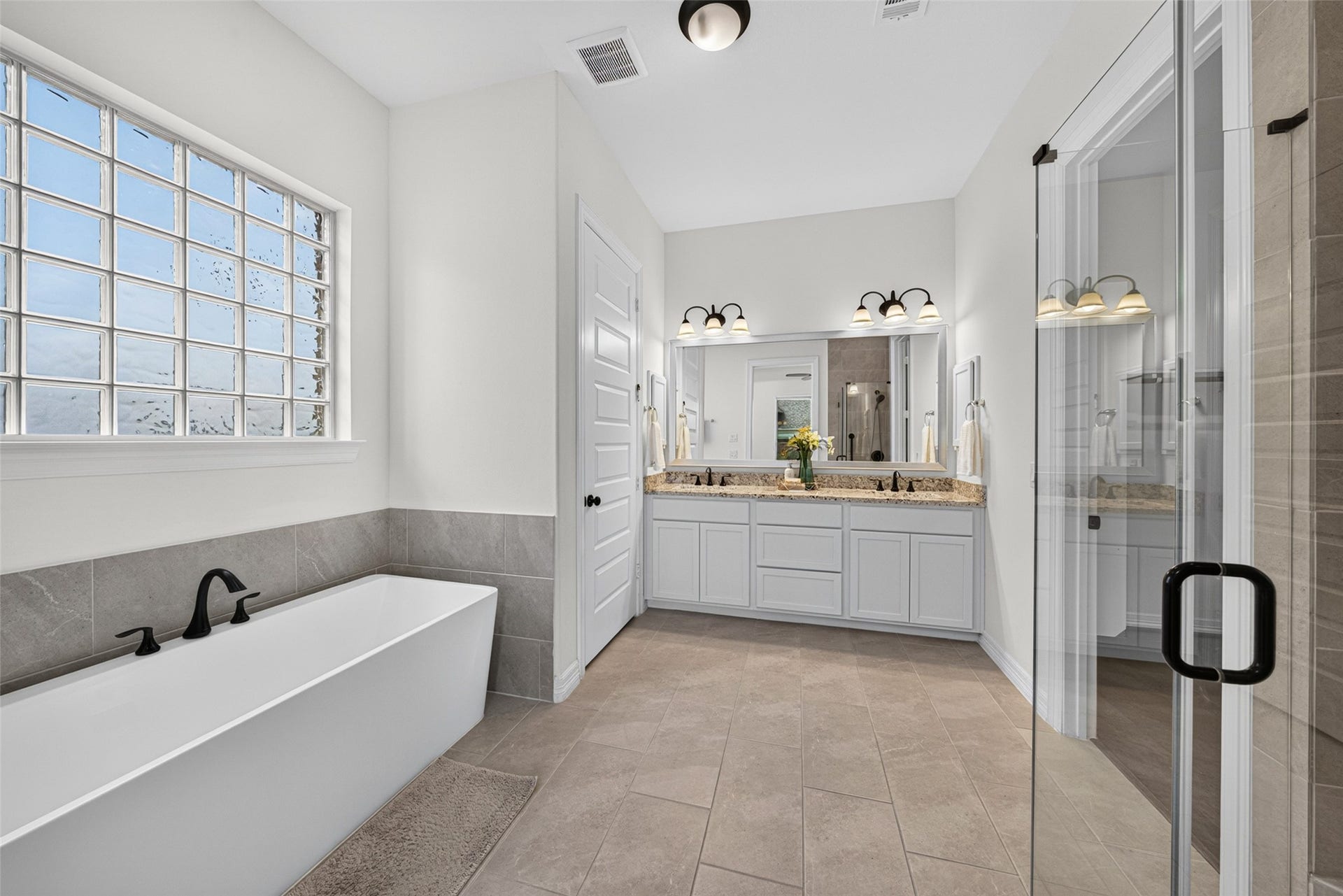 10706 Hazel Hills Drive, Cypress, TX 77433 Indulge in pure relaxation in the deep soaking tub, serving as a serene focal point in the primary en suite.