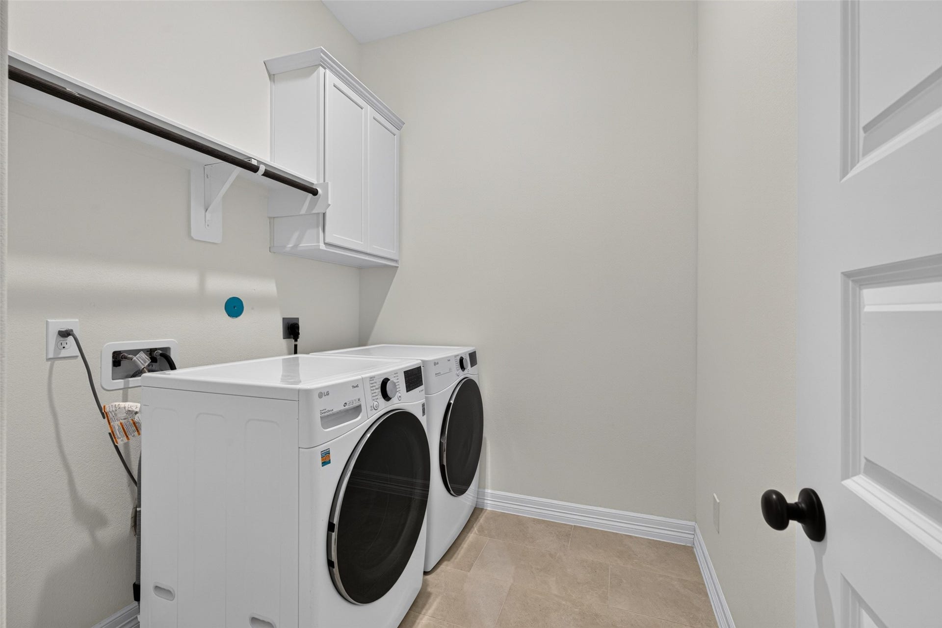 10706 Hazel Hills Drive, Cypress, TX 77433 This practical and dedicated laundry room offers convenient built-in storage and upper shelving, making daily chores organized and effortless.