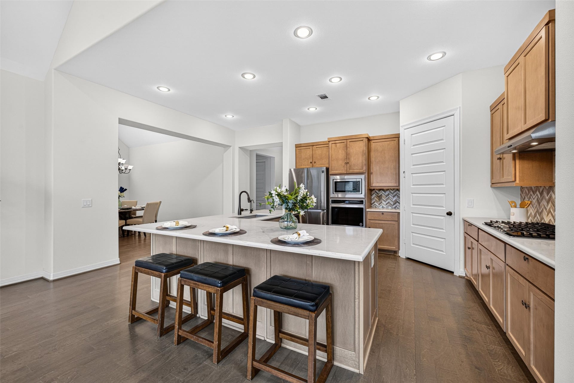 10706 Hazel Hills Drive, Cypress, TX 77433 The stunning L-shaped quartz island serves as the ultimate anchor for both morning coffee routines and casual evening gatherings.