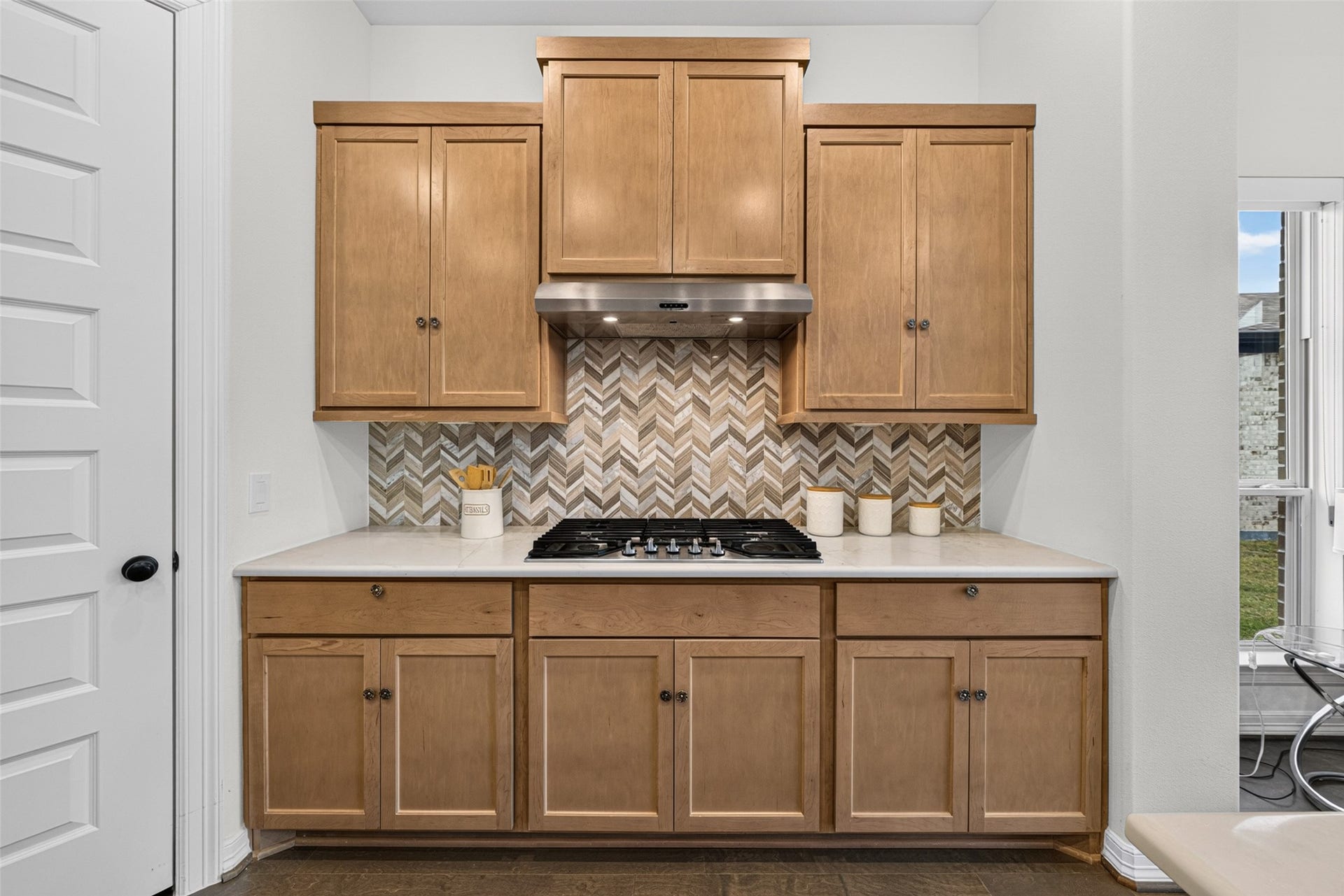 10706 Hazel Hills Drive, Cypress, TX 77433 Exquisite custom cabinetry brings rich texture and practical storage solutions, keeping all your culinary essentials neatly organized.