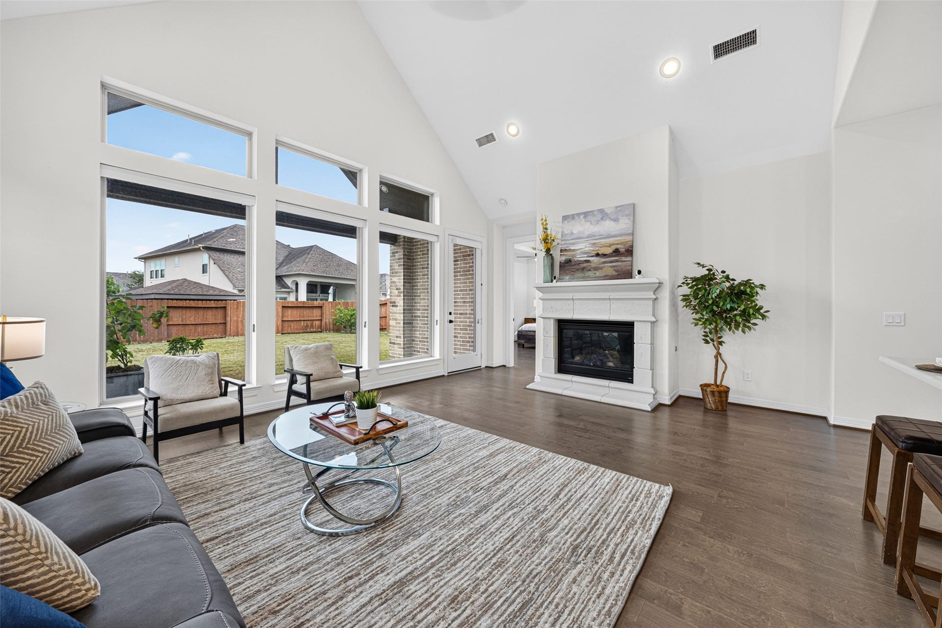 10706 Hazel Hills Drive, Cypress, TX 77433 The heart of the home opens up into a luminous living room framed by wide, expansive windows that draw in an abundance of natural light.