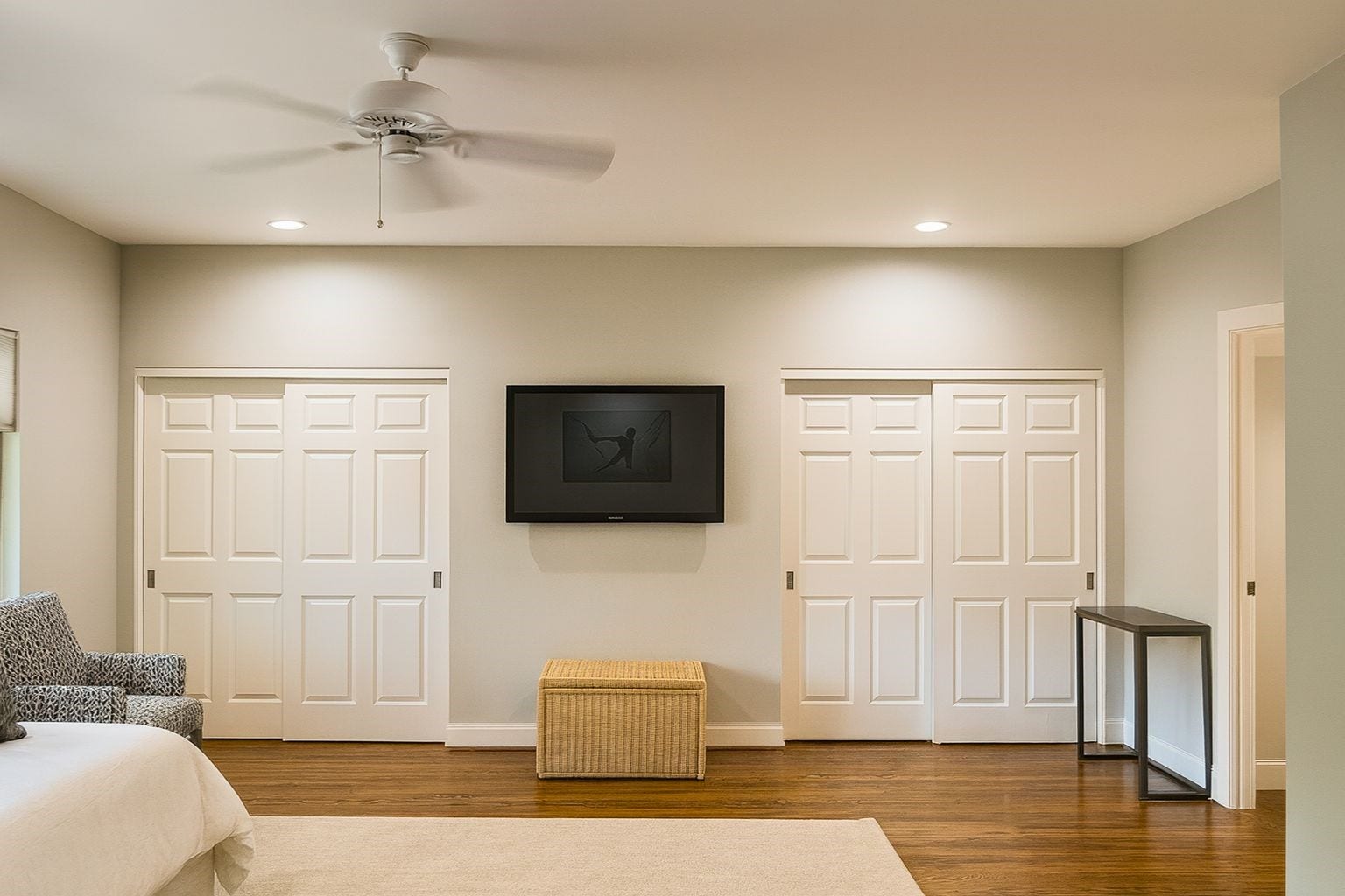 3027 Bissonnet Street, Houston, TX 77005 The primary suite (digitally staged) is a spacious retreat, comfortably fitting a king bed with room to spare for a seating area, while large windows frame serene outdoor views.