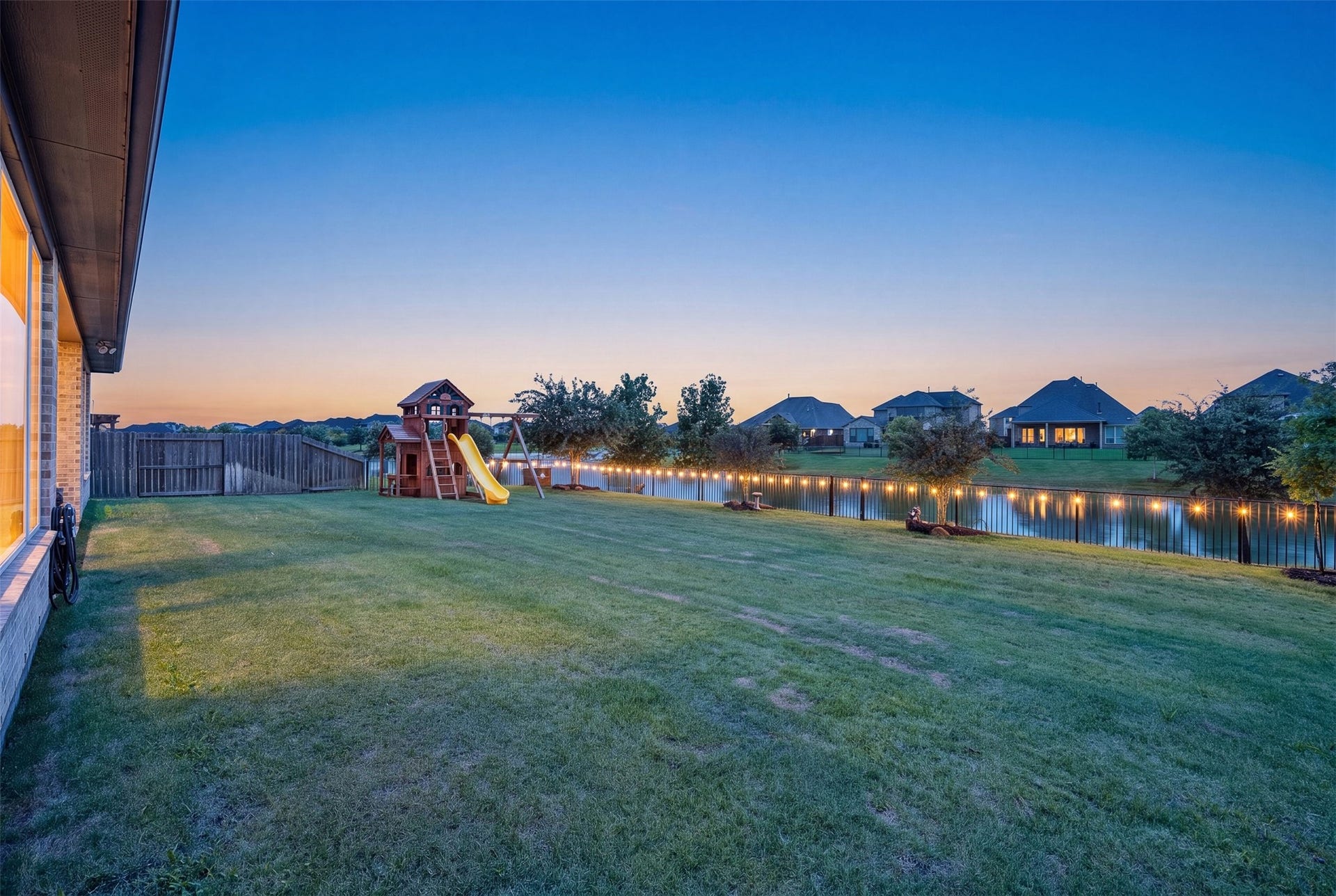 Experience tranquil outdoor living with a spacious backyard showcasing picturesque views of the community lake and convenient access to the natural beauty just beyond your doorstep.